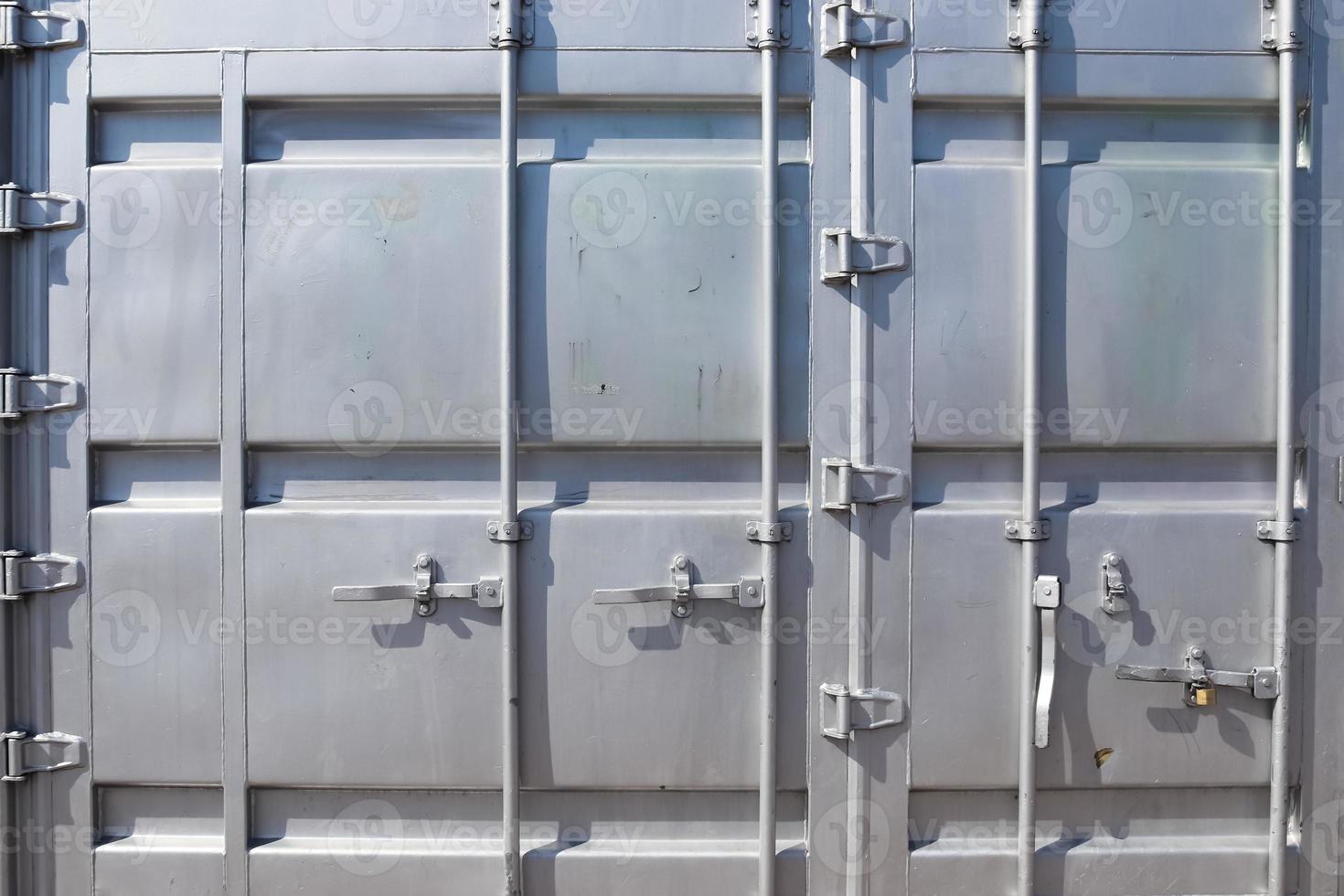 Detailed close up view on metal and steel surfaces on a silver cargo containter photo