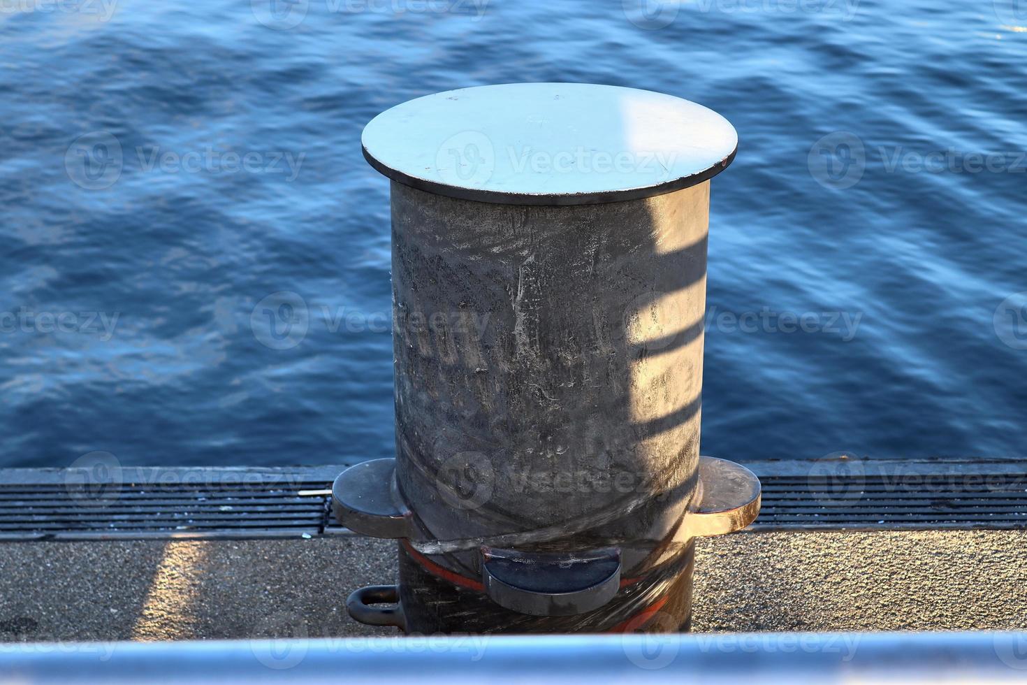 Different bollards and technical installations of vessel traffic at a port photo