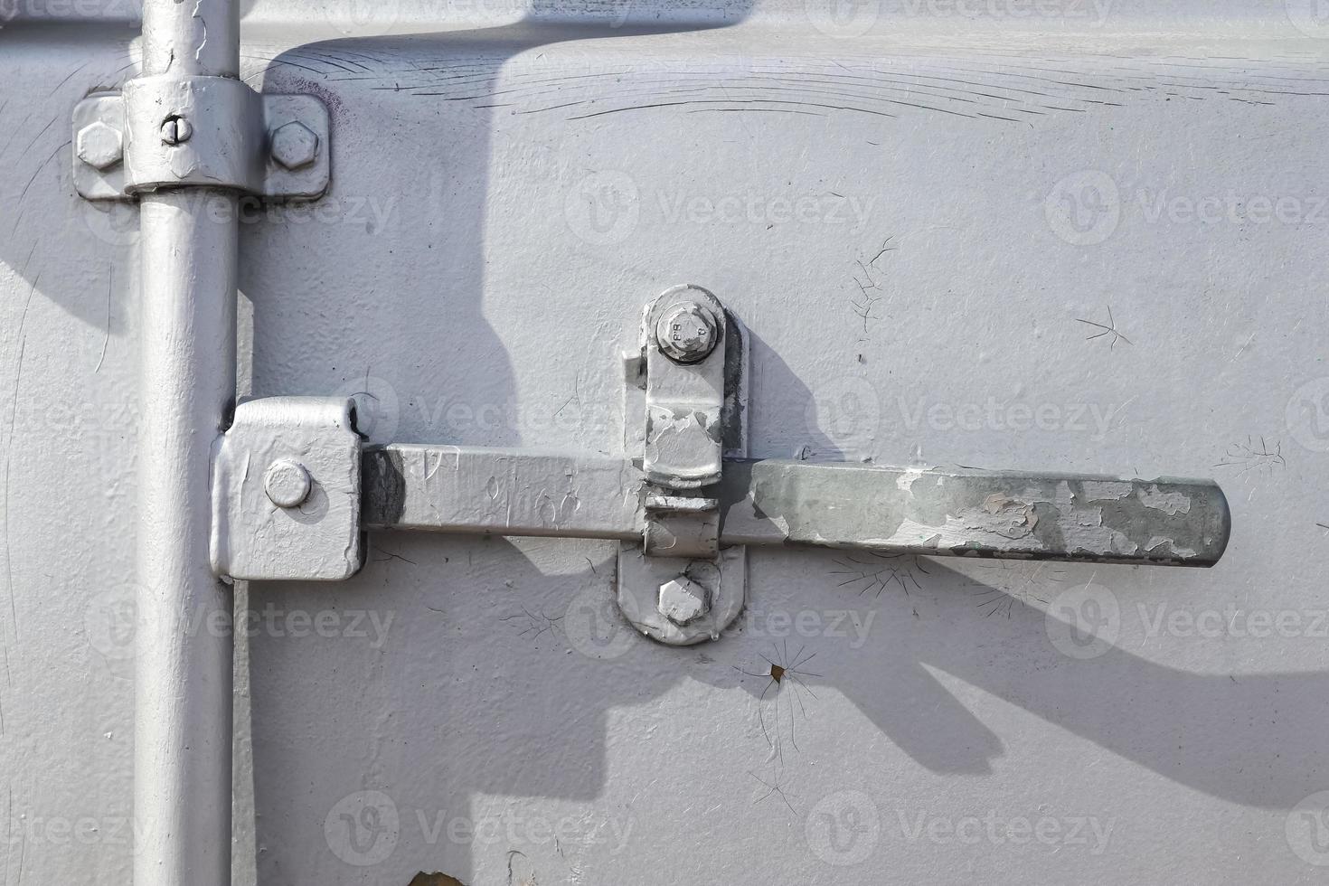 Detailed close up view on metal and steel surfaces on a silver cargo containter photo