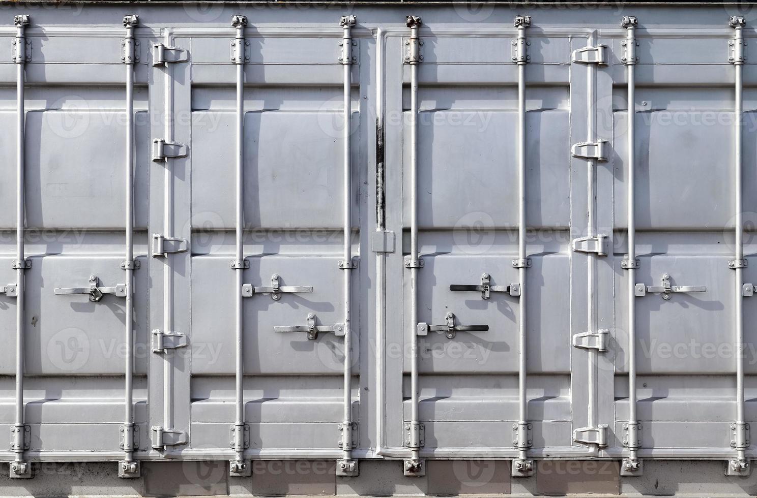 Detailed close up view on metal and steel surfaces on a silver cargo containter photo