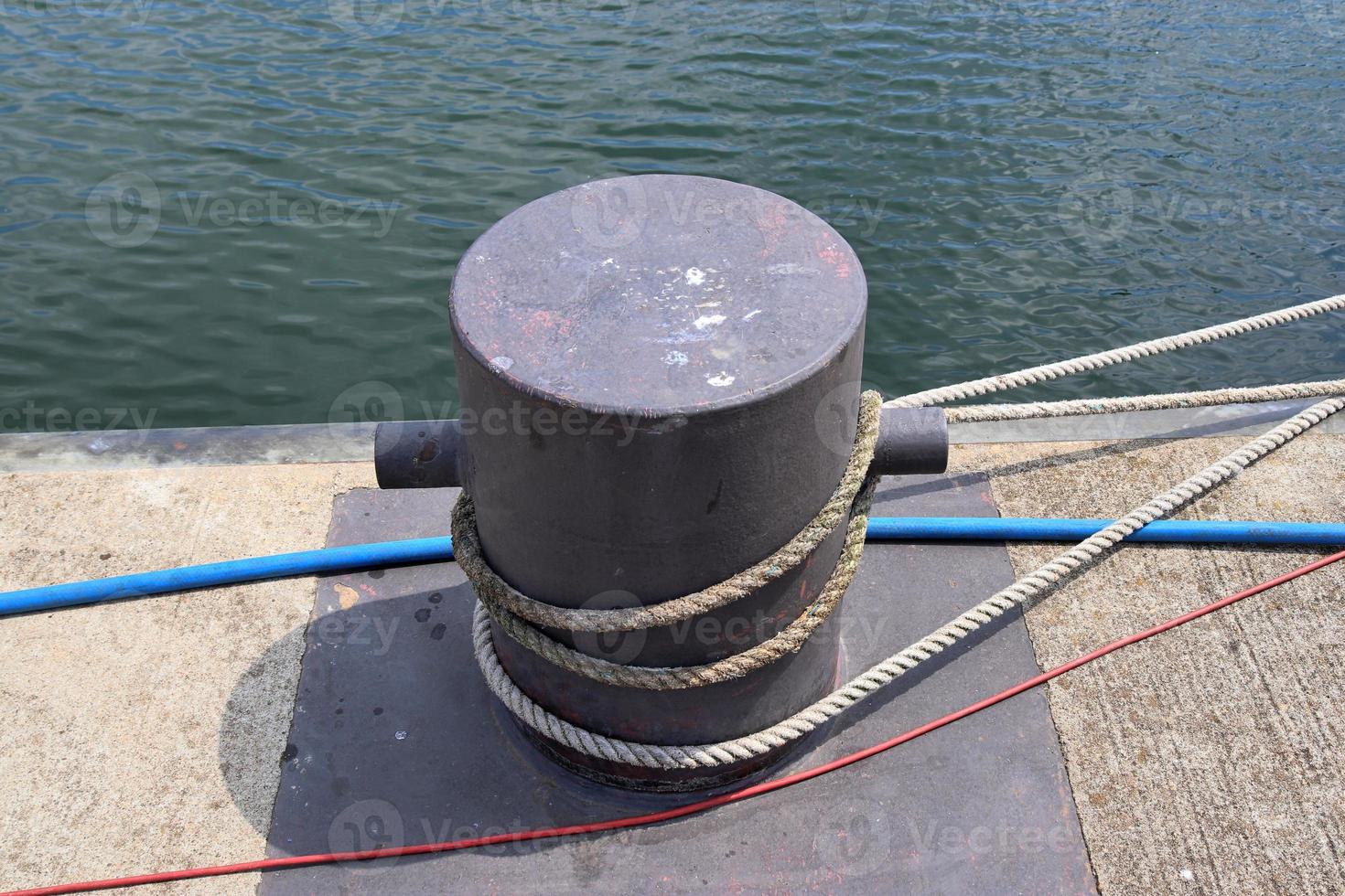 Different bollards and technical installations of vessel traffic at a port photo