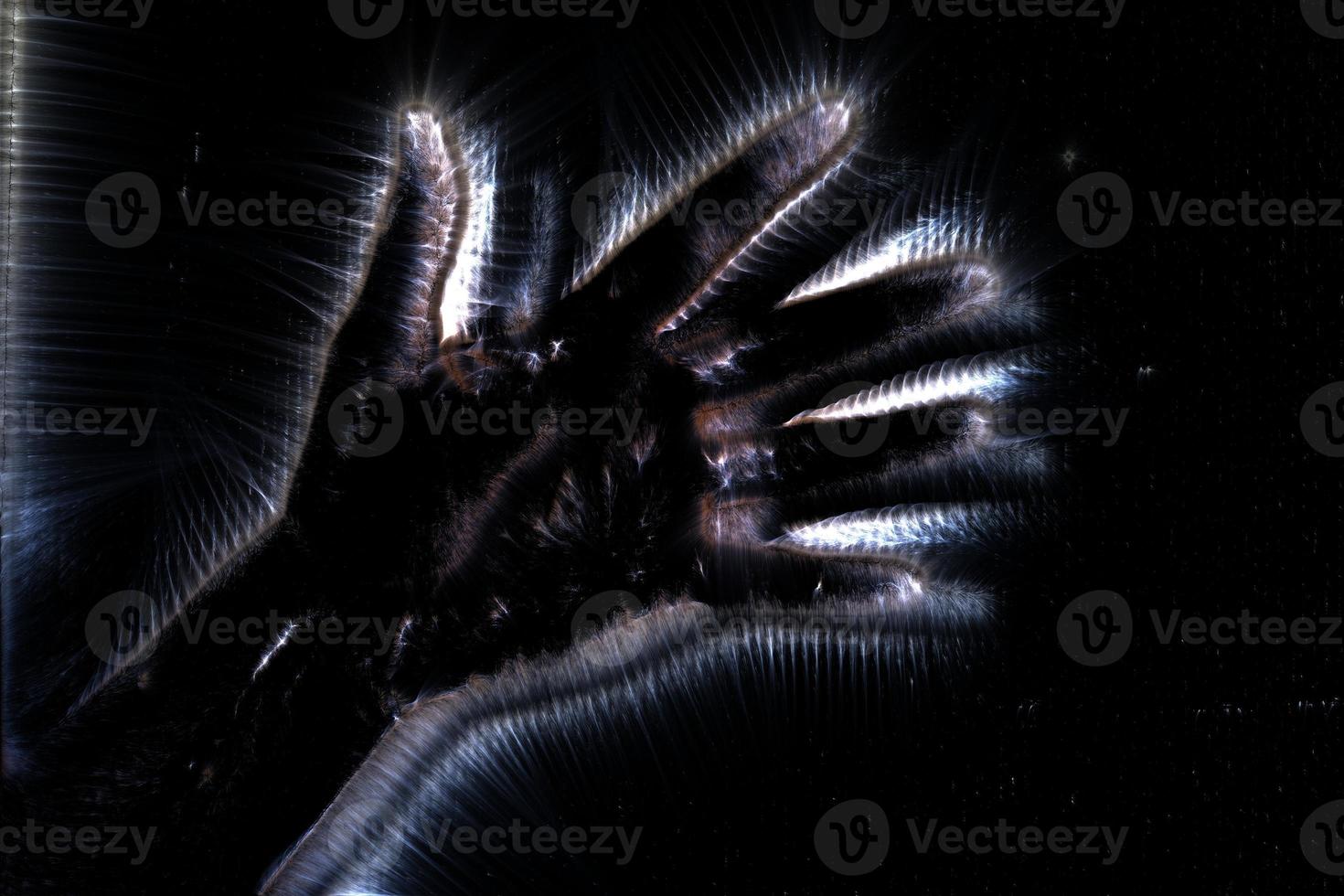3D-Illustration of a glowing human female hand with a kirlian aura showing different symbols photo