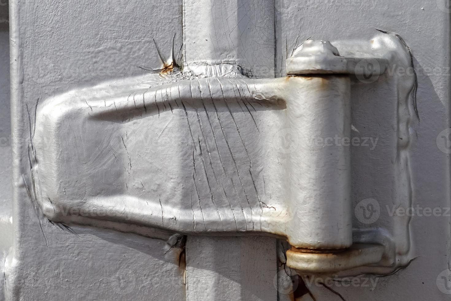 Detailed close up view on metal and steel surfaces on a silver cargo containter photo