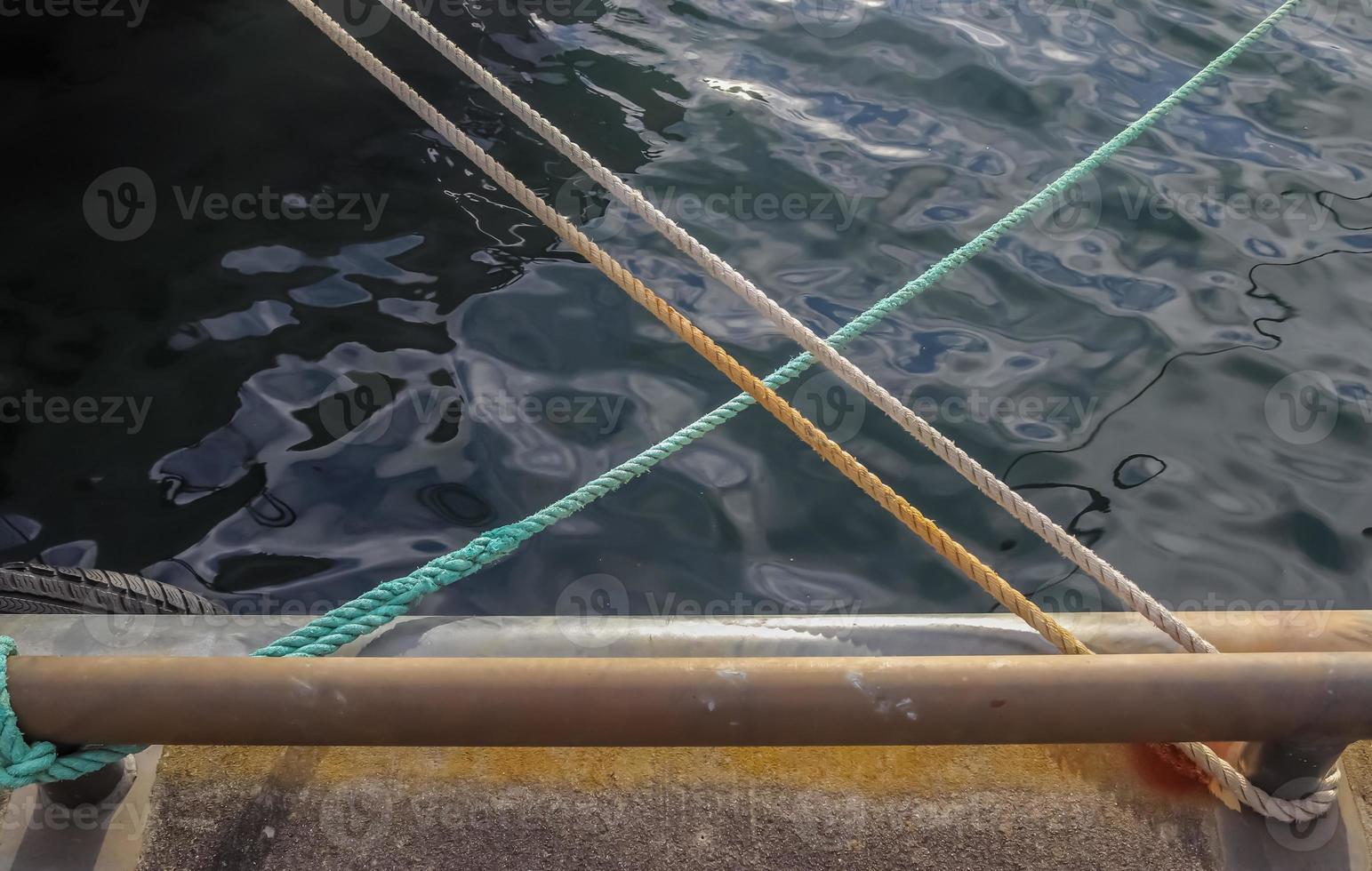 Detailed close up detail of ropes and cordage in the rigging of an old wooden vintage sailboat photo