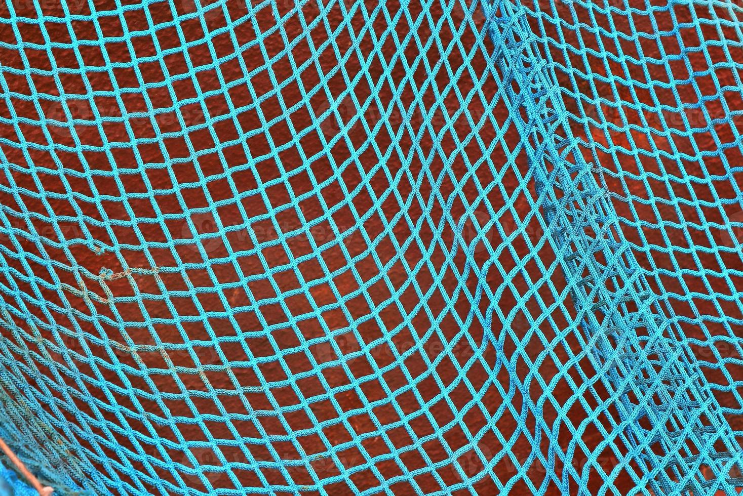 Close up on a blue fishing net at the harbour of Kiel in Germany photo