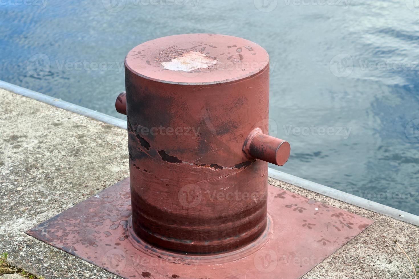 Different bollards and technical installations of vessel traffic at a port photo