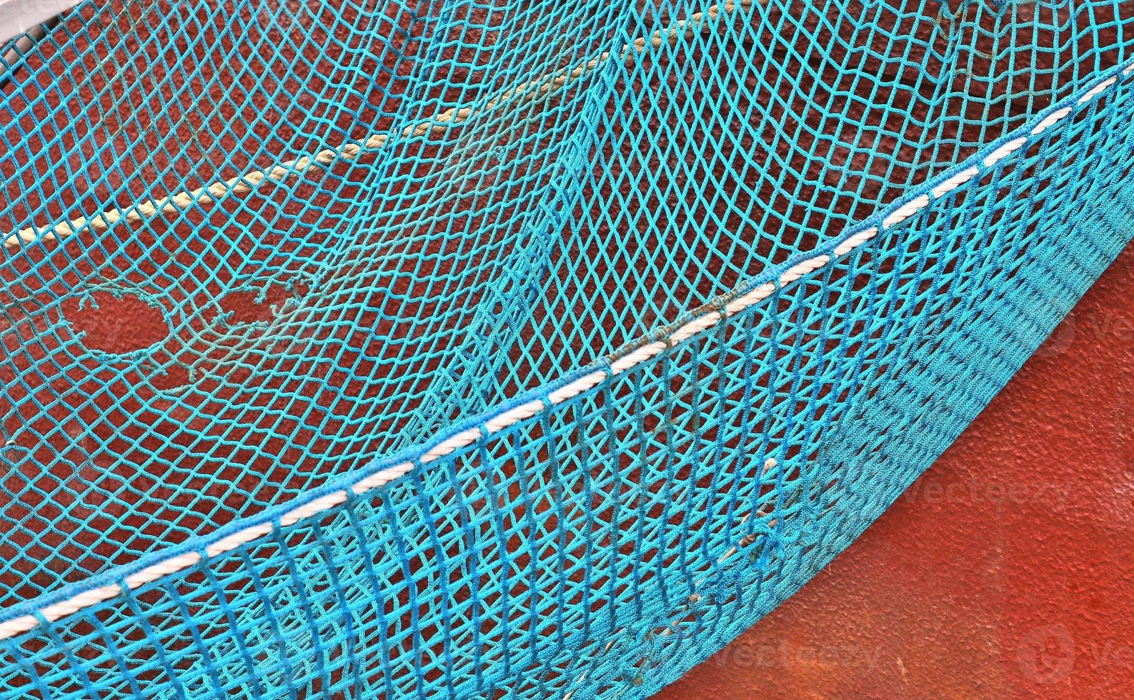 Close up on a blue fishing net at the harbour of Kiel in Germany photo