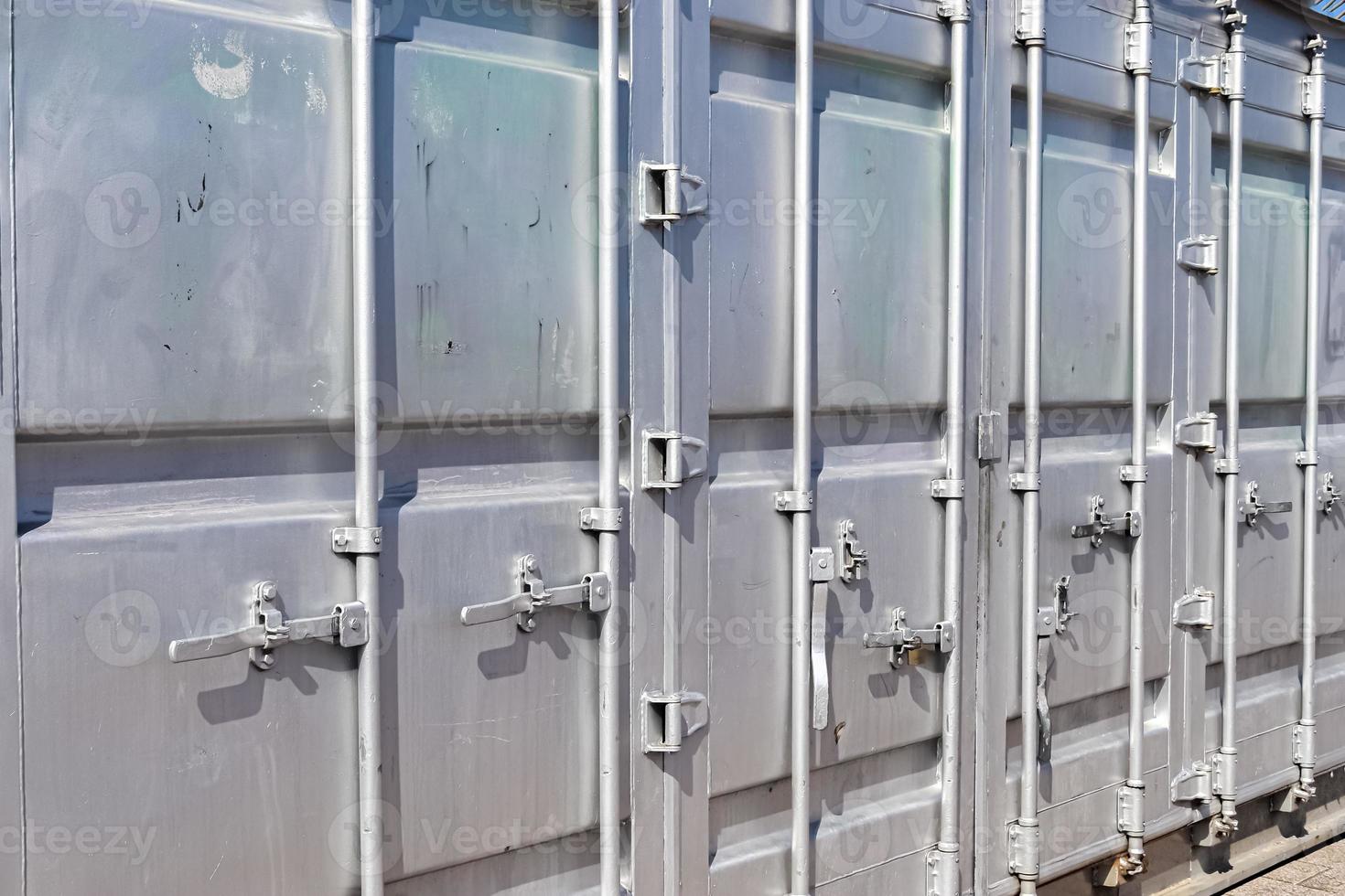 Detailed close up view on metal and steel surfaces on a silver cargo containter photo