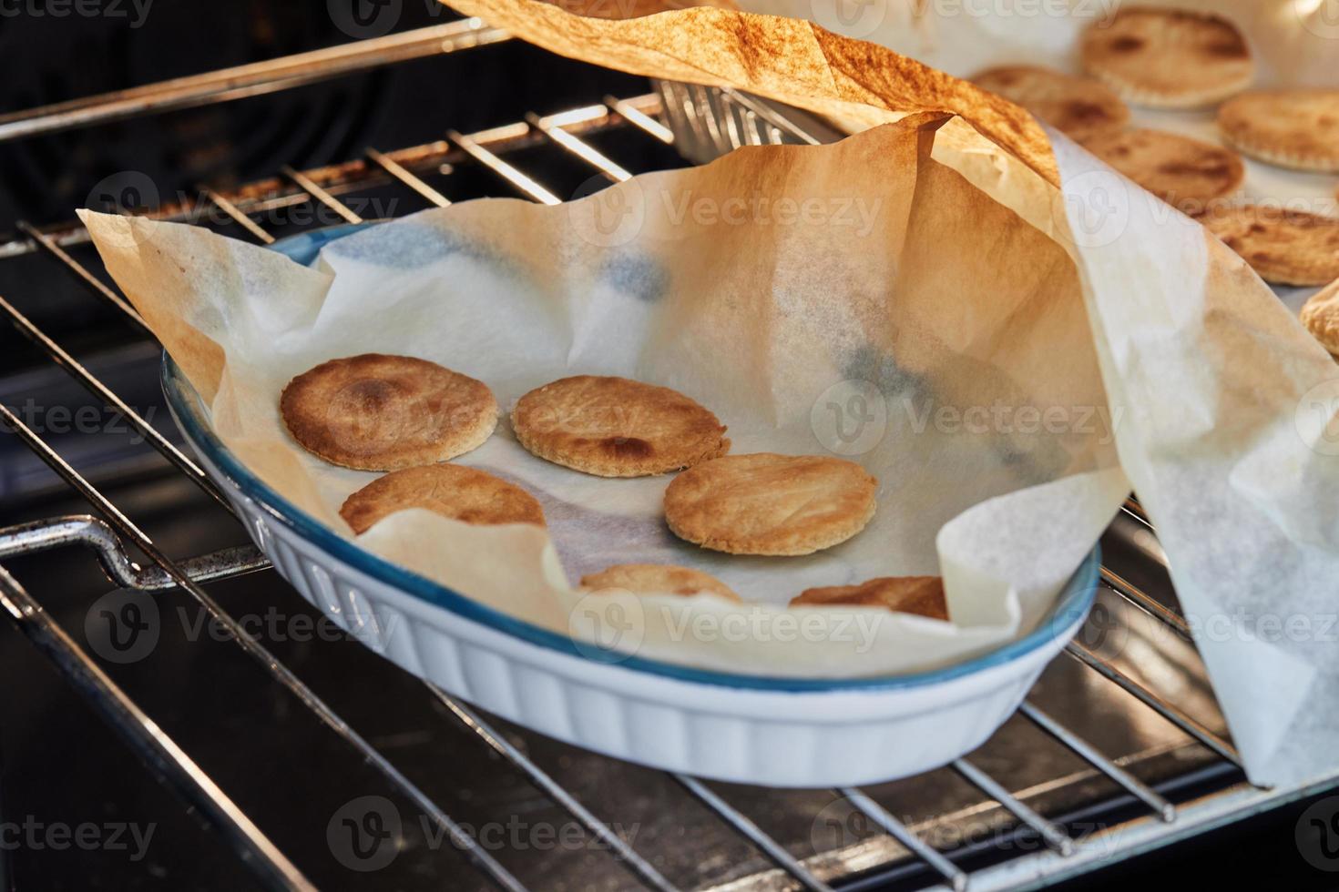 Dough circles are ready after baking in the oven for appetizer with ricotta cheese and cherry tomatoes photo