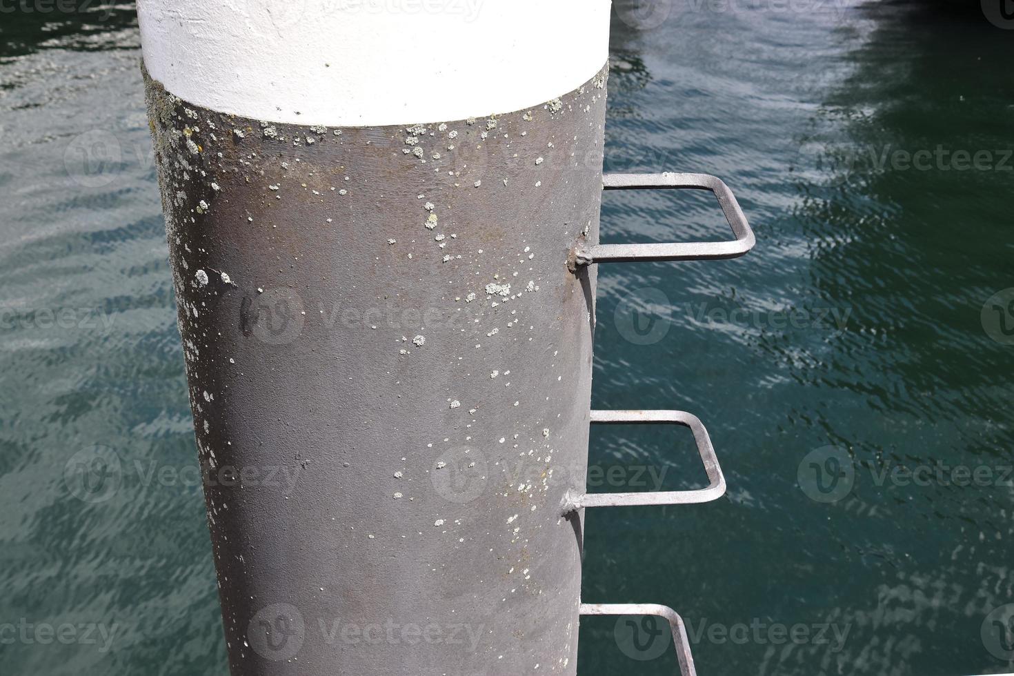 Different bollards and technical installations of vessel traffic at a port photo
