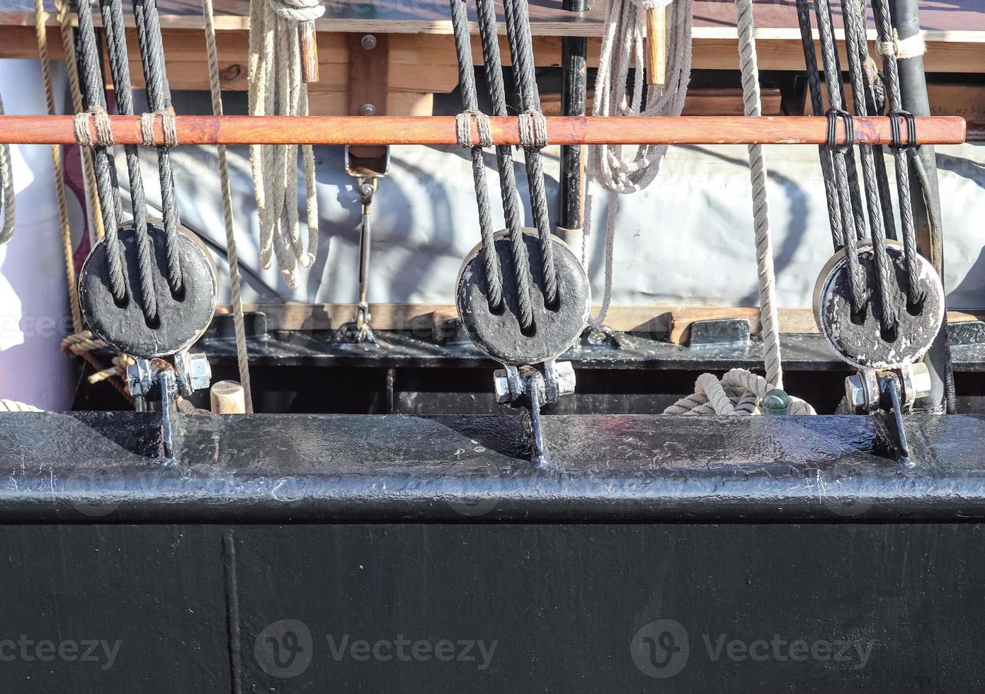 Detailed close up detail of ropes and cordage in the rigging of an old wooden vintage sailboat photo