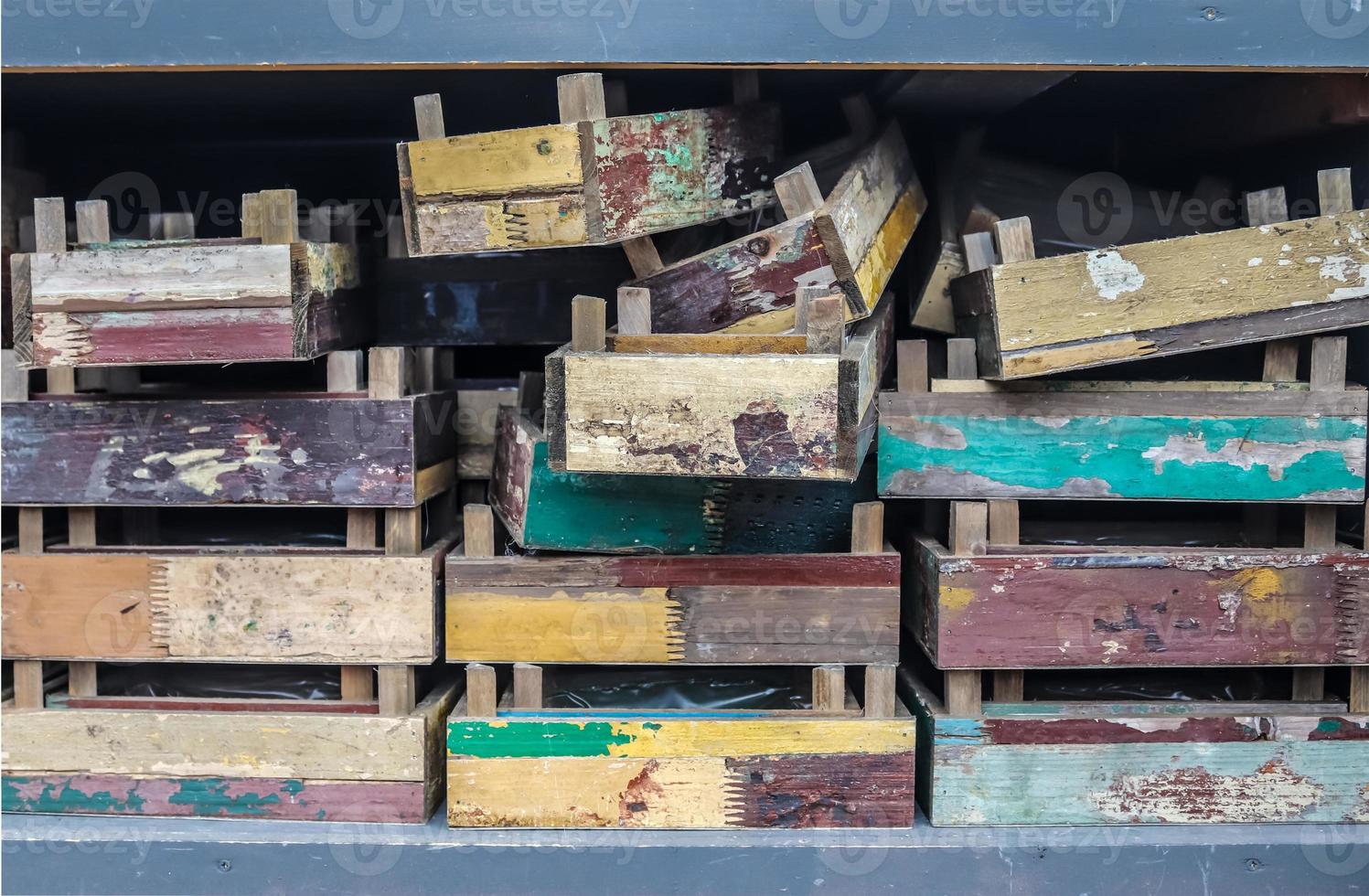 Vintage wooden crates in a shelf for sale in a small shop. photo