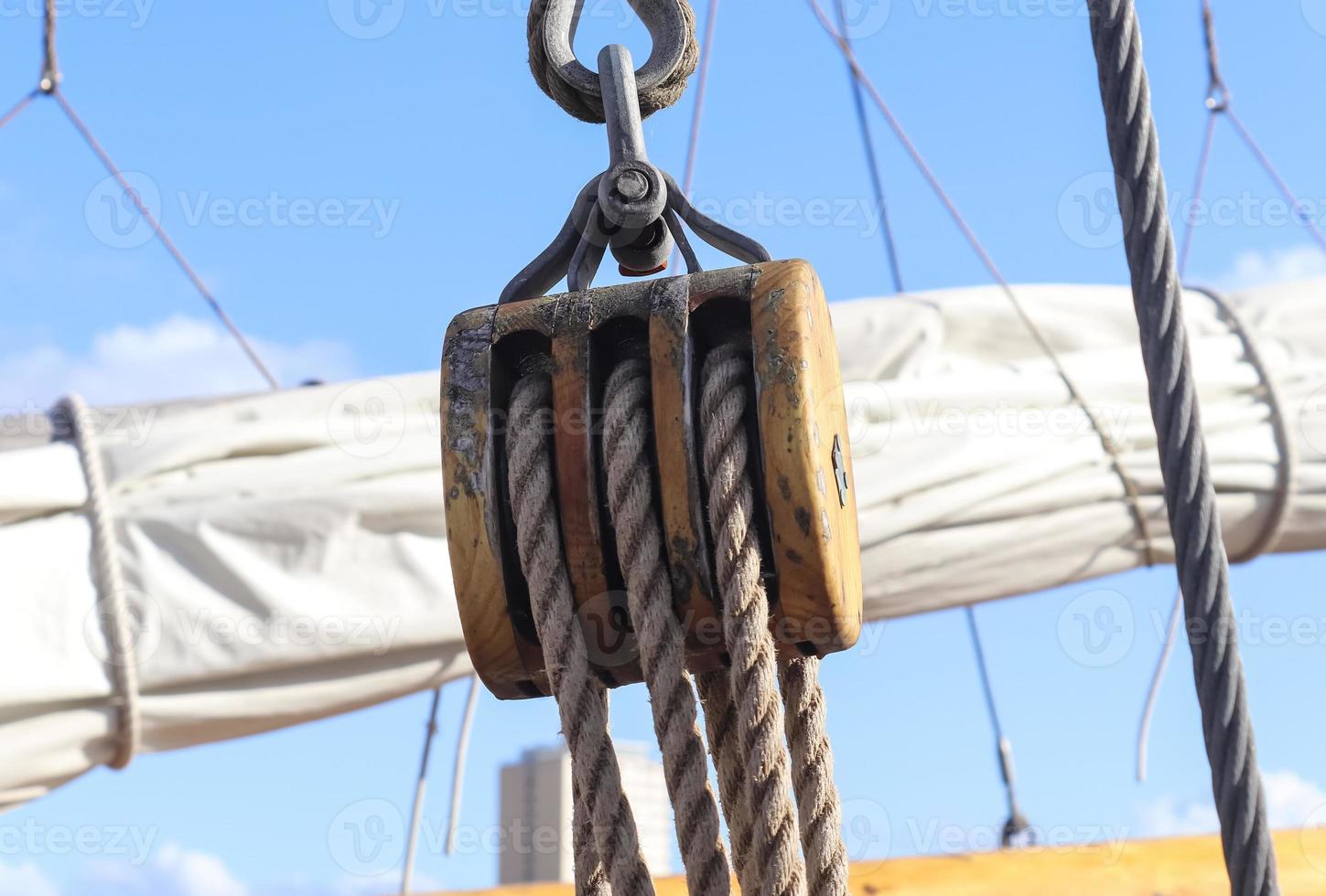 Detailed close up detail of ropes and cordage in the rigging of an old wooden vintage sailboat photo