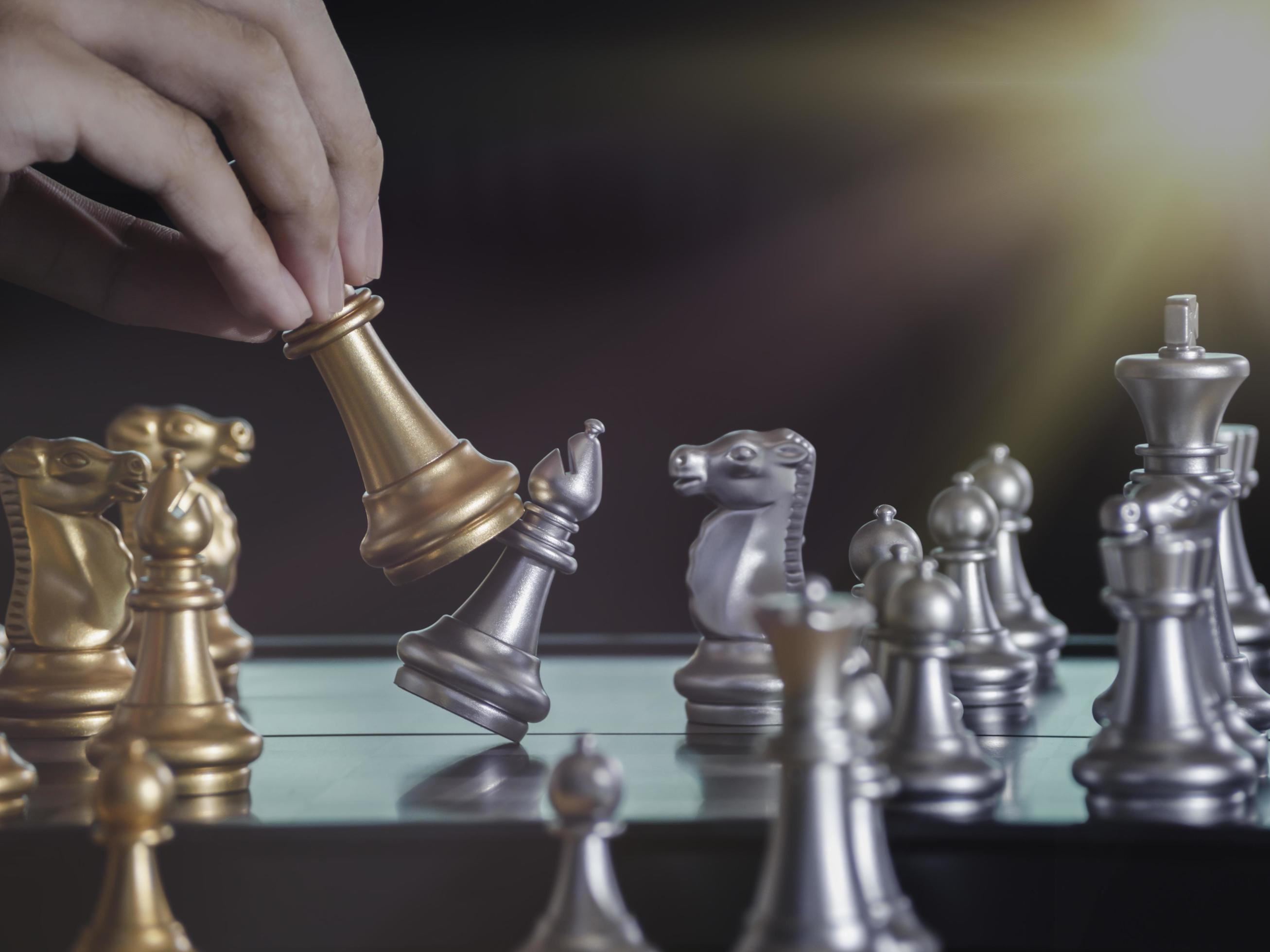 Concentrated serious boy developing chess gambit, strategy ,playing board  game to winner clever concentration and thinking child while playing chess.  Learning, tactics and analysis concept. Free Photo