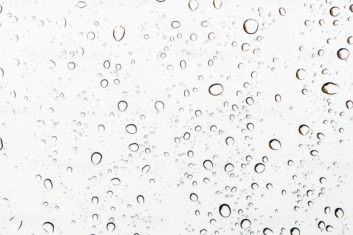 Raindrops on a glass, abstract white background. photo