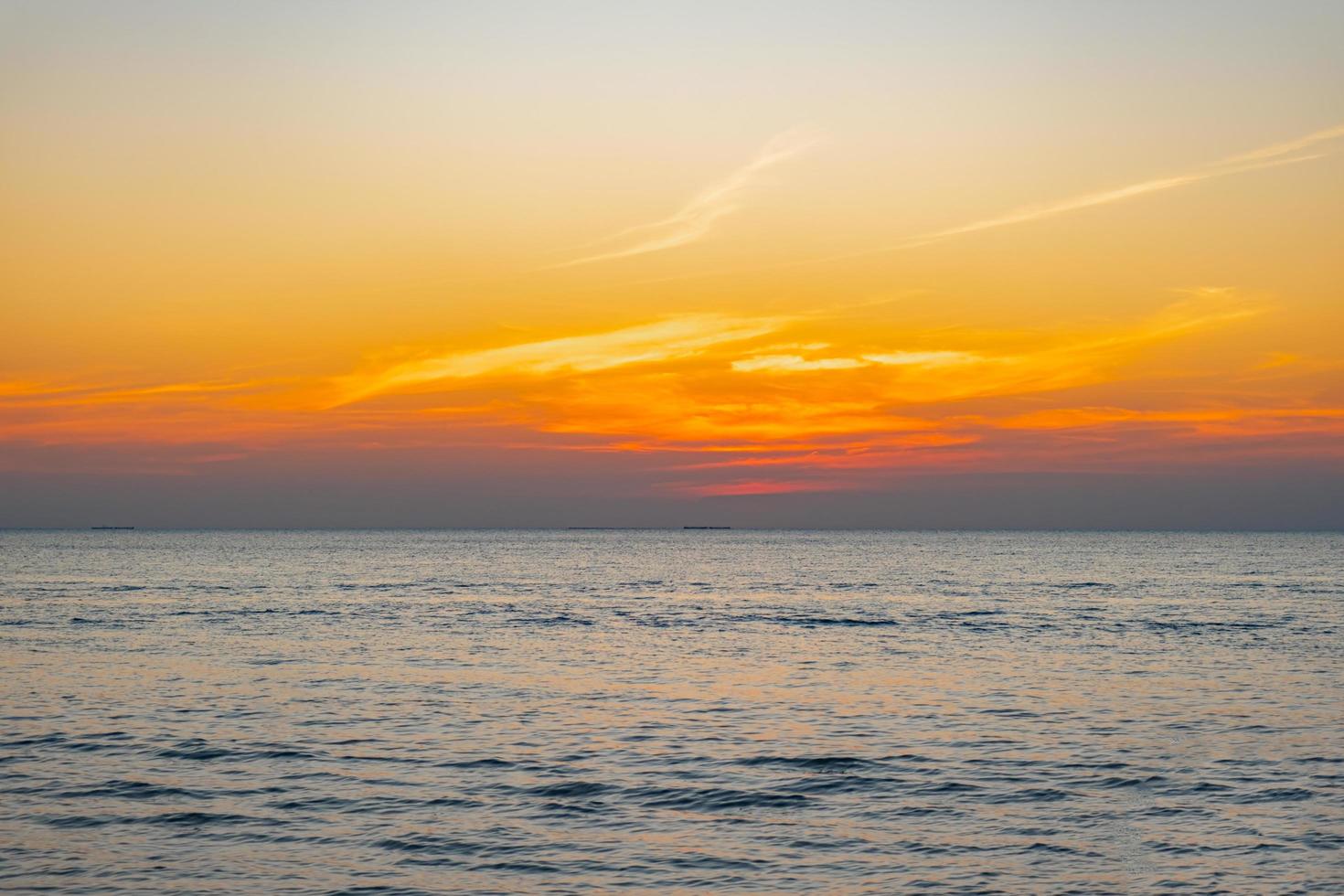 blurred of Tropical Colorful sunset over ocean on the beach. at Thailand Tourism background with sea beach. Holiday journey destination photo