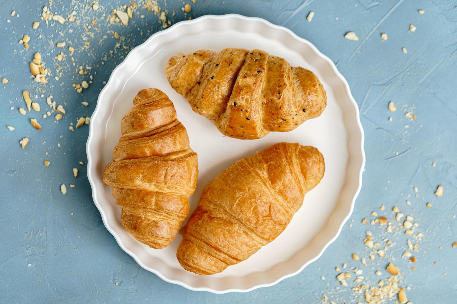 freshly baked croissants on white plate. French and American Croissants and Baked Pastries are enjoyed world wide. photo