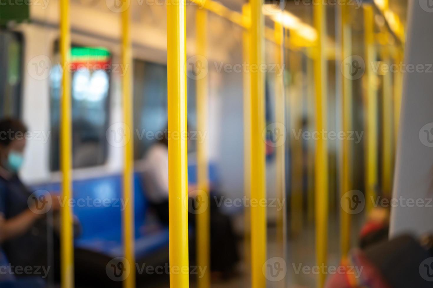 Yellow pole for the passenger to hold while transport inside Airport Rail Link Train. photo