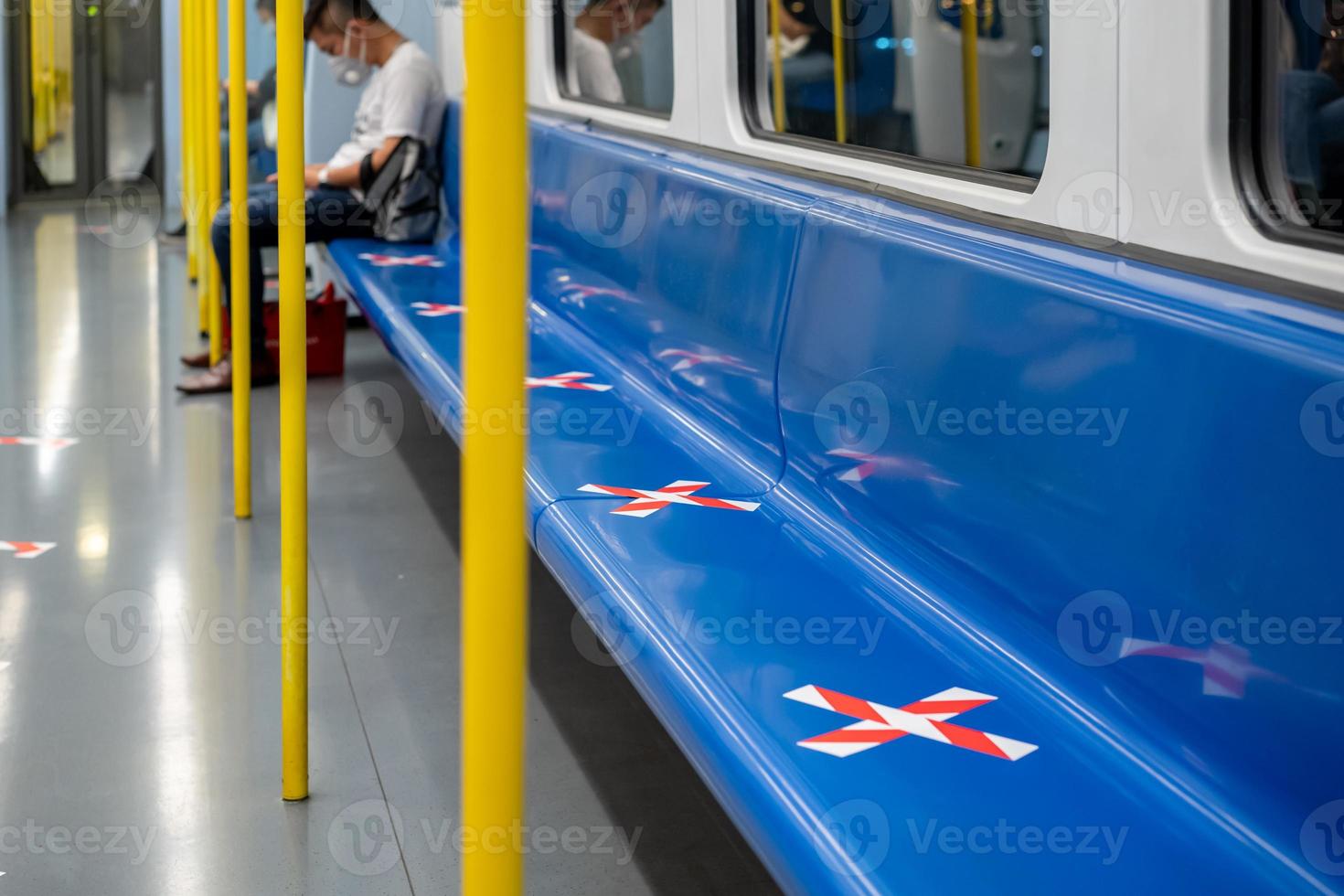 blue seat row in the train with crossed marking tape in Coronavirus COVID-19 period. It means Social Distancing in transportation. photo