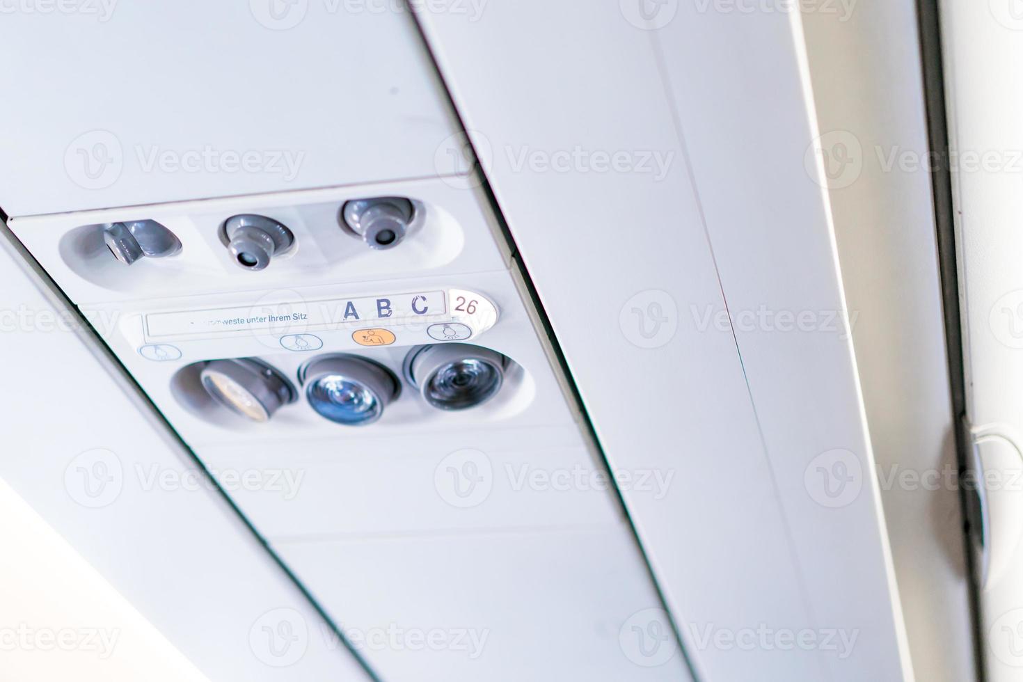 closeup airplane Console panel lamp, light, need help button, air condition, sefty belt and no smoking lighting sign. photo