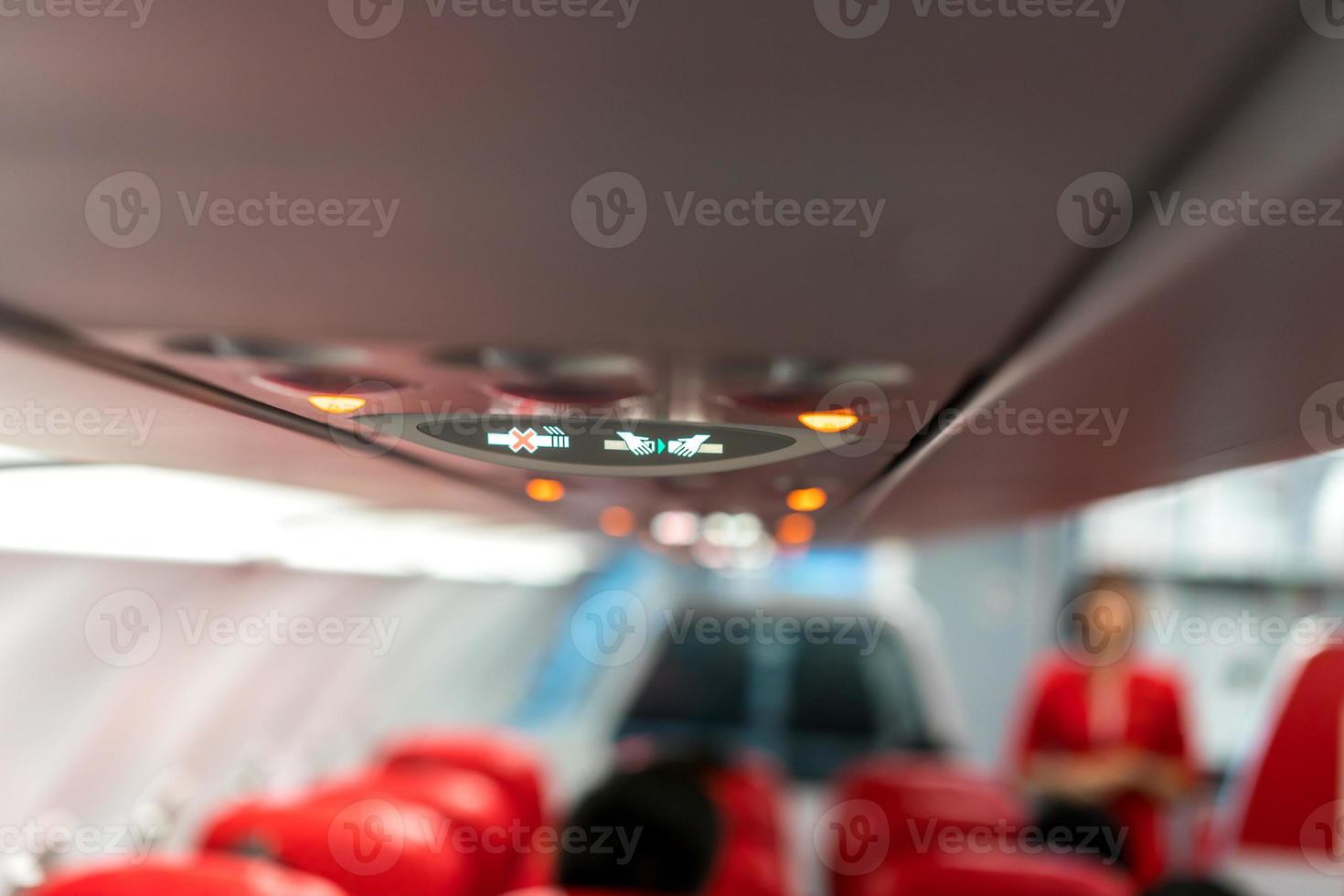 closeup airplane Console panel lamp, light, need help button, air condition, sefty belt and no smoking lighting sign. photo
