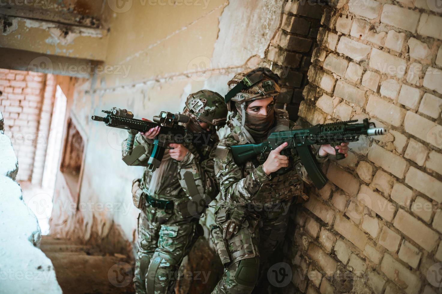 Military portrait of girls in the hands they hold a rifle photo