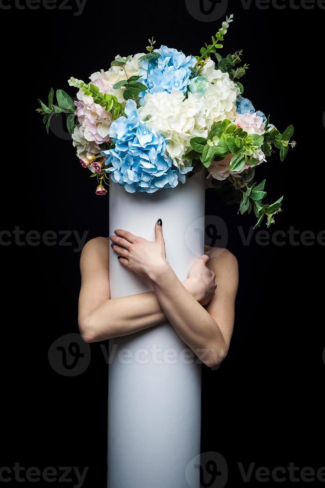 girl with a bouquet of flowers on an isolated black background photo