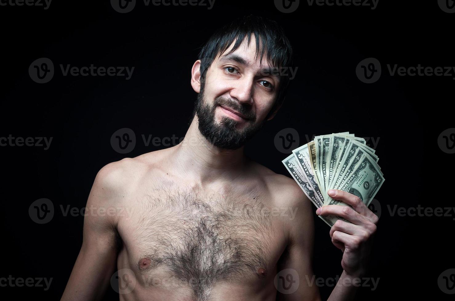 Young man with banknotes on black background photo