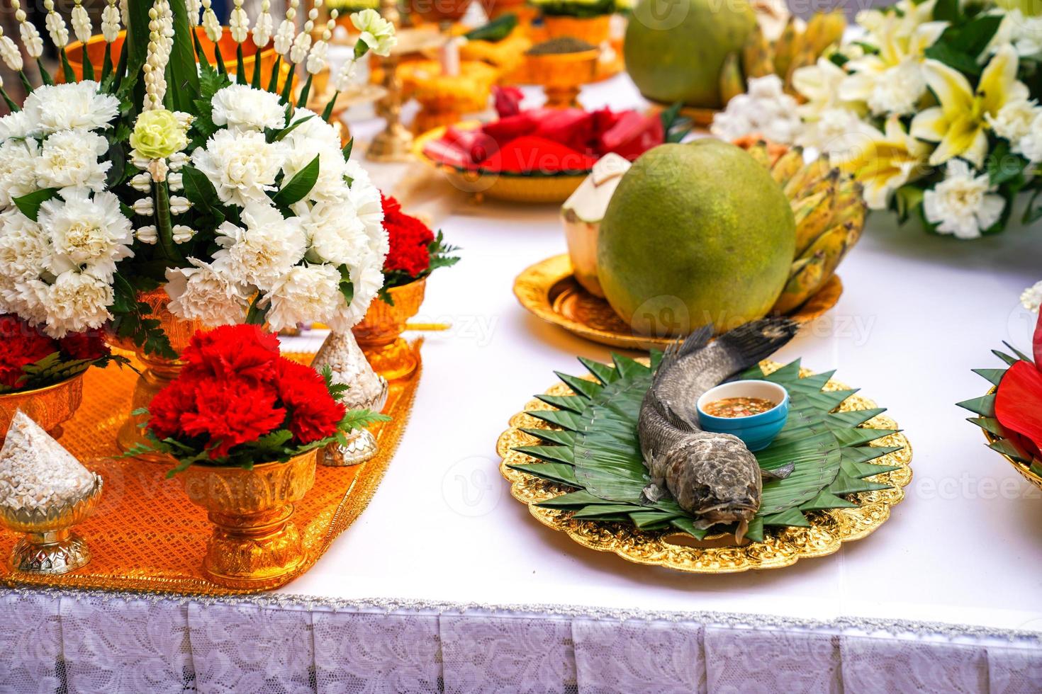 Thai rice offering, catfish, coconut, pomelo, banana photo
