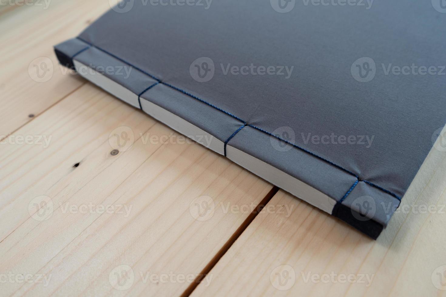 classic black notebook on the wood table. photo