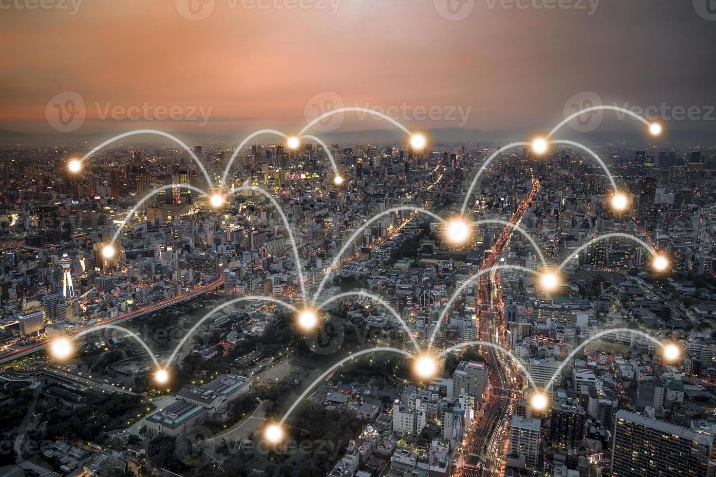 Network connection curve light line at the top of the building and light point all connection in panoramic metropolis cityscape with transportation around area in orange twilight time. Clipping path. photo