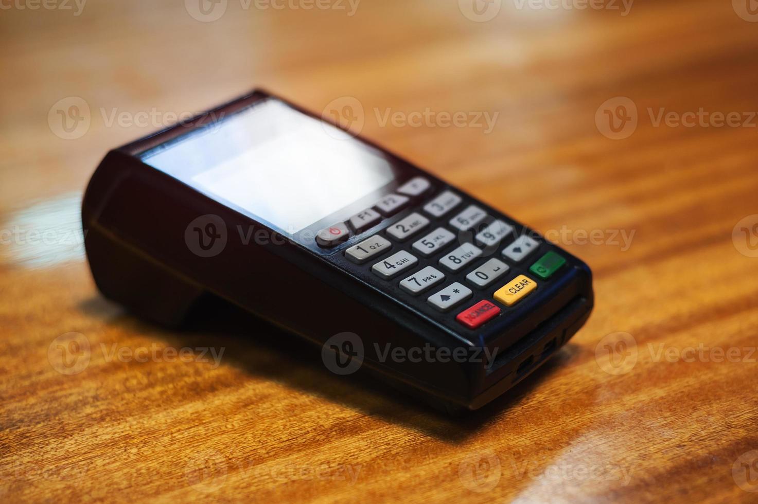 Payment terminal lying on a wooden table photo