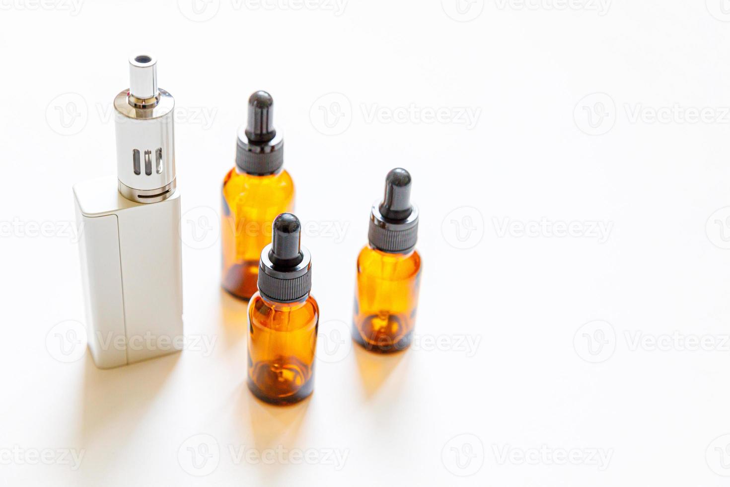 Vaping device e-cigarette electronic cigarette and liquid bottles isolated on white background. Vape device for alternative smoking. Vaping shop concept. Gadget for vaper. Vaping accessories. photo