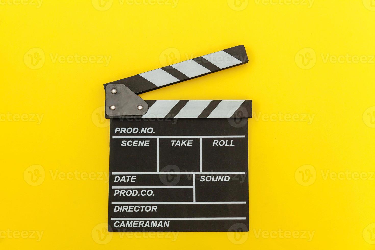 Filmmaker profession. Classic director empty film making clapperboard or movie slate isolated on yellow background. Video production film cinema industry concept. Flat lay top view copy space mock up. photo