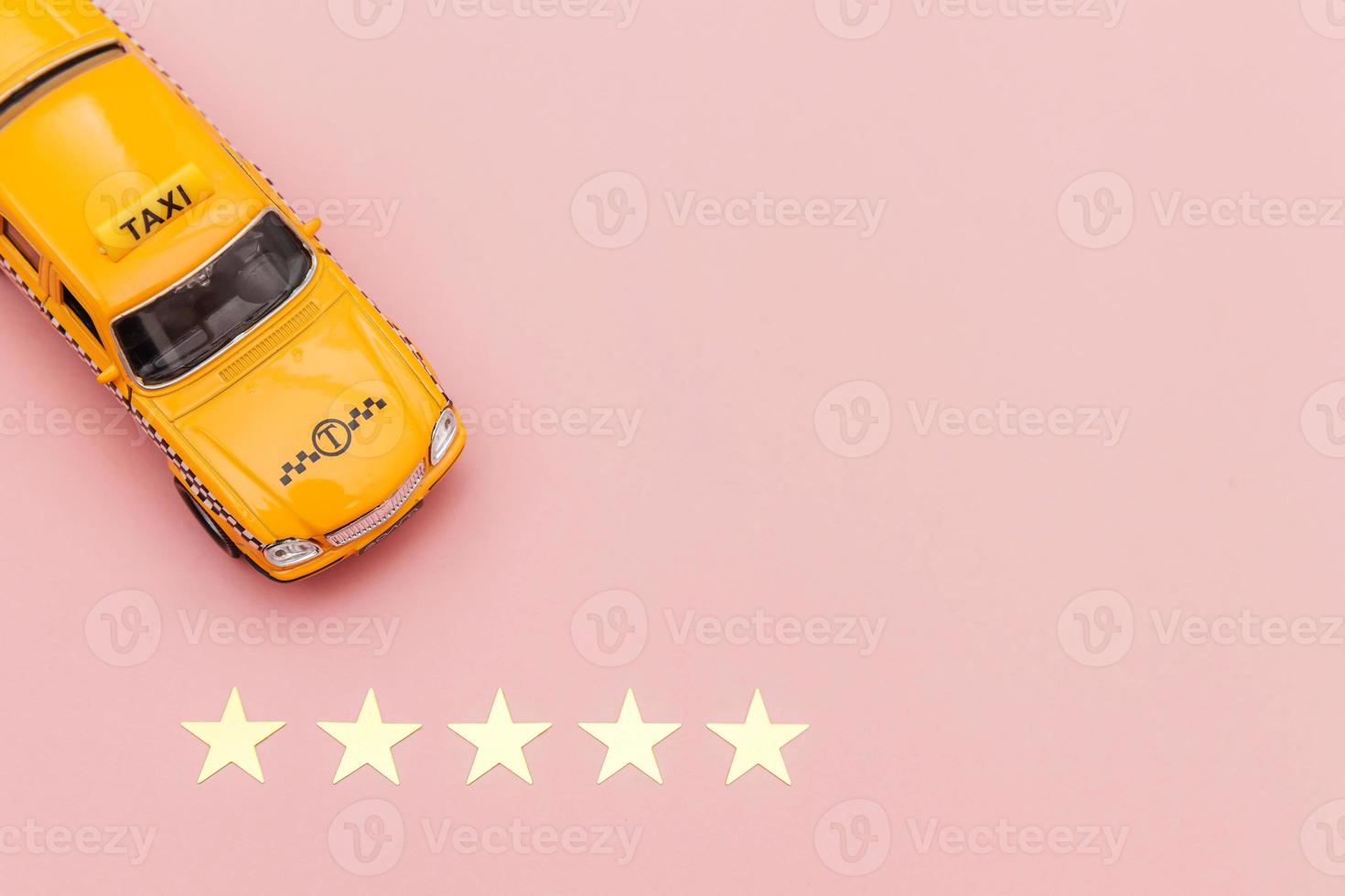 Yellow toy car Taxi Cab and 5 stars rating isolated on pink background. Smartphone application of taxi service for online searching calling and booking cab concept. Taxi symbol. Copy space. photo