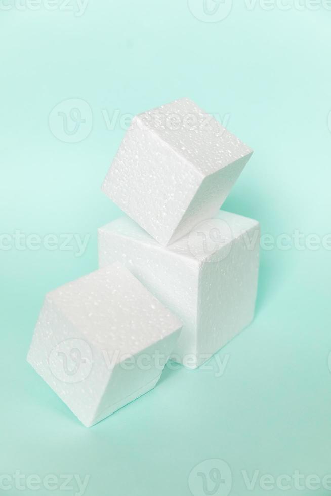 White rectangular cube shapes on blue background. Minimal boxes geometric forms podium. Empty unbranded shopfront. Showcase for cosmetic product. Mockup style design. Cosmetology and beauty concept. photo