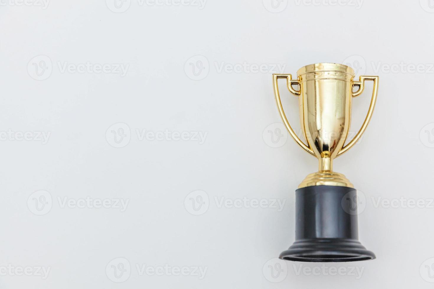 Simply flat lay design winner or champion gold trophy cup isolated on white background. Victory first place of competition. Winning or success concept. Top view copy space. photo