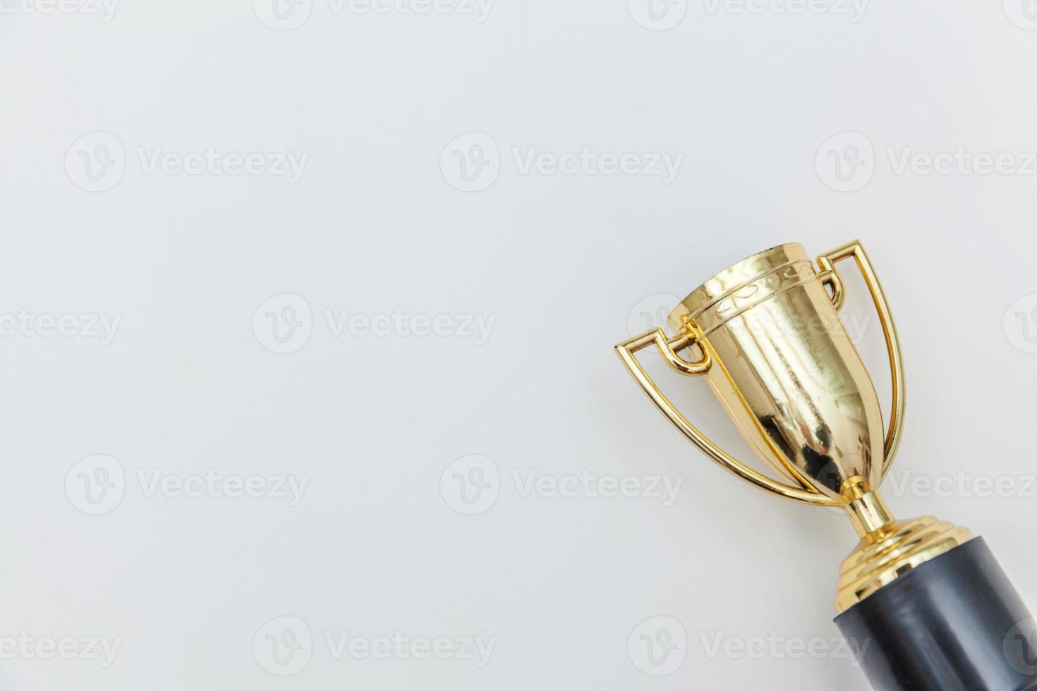 Simply flat lay design winner or champion gold trophy cup isolated on white background. Victory first place of competition. Winning or success concept. Top view copy space. photo