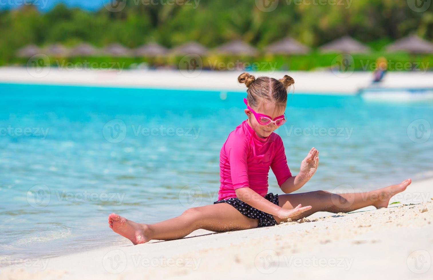 Adorable little girl at beach during summer vacation photo