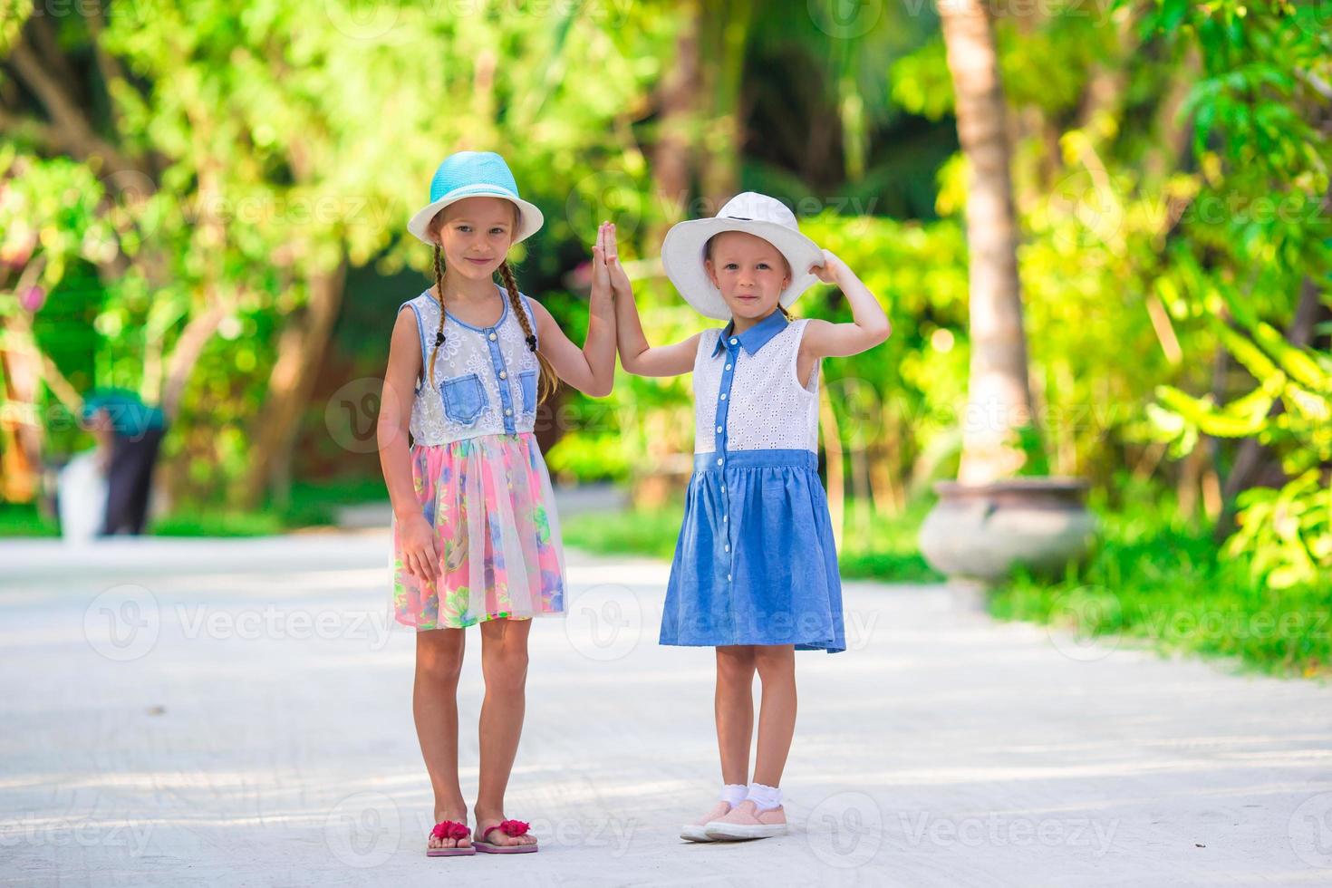 Adorable little girls during summer tropical vacation photo