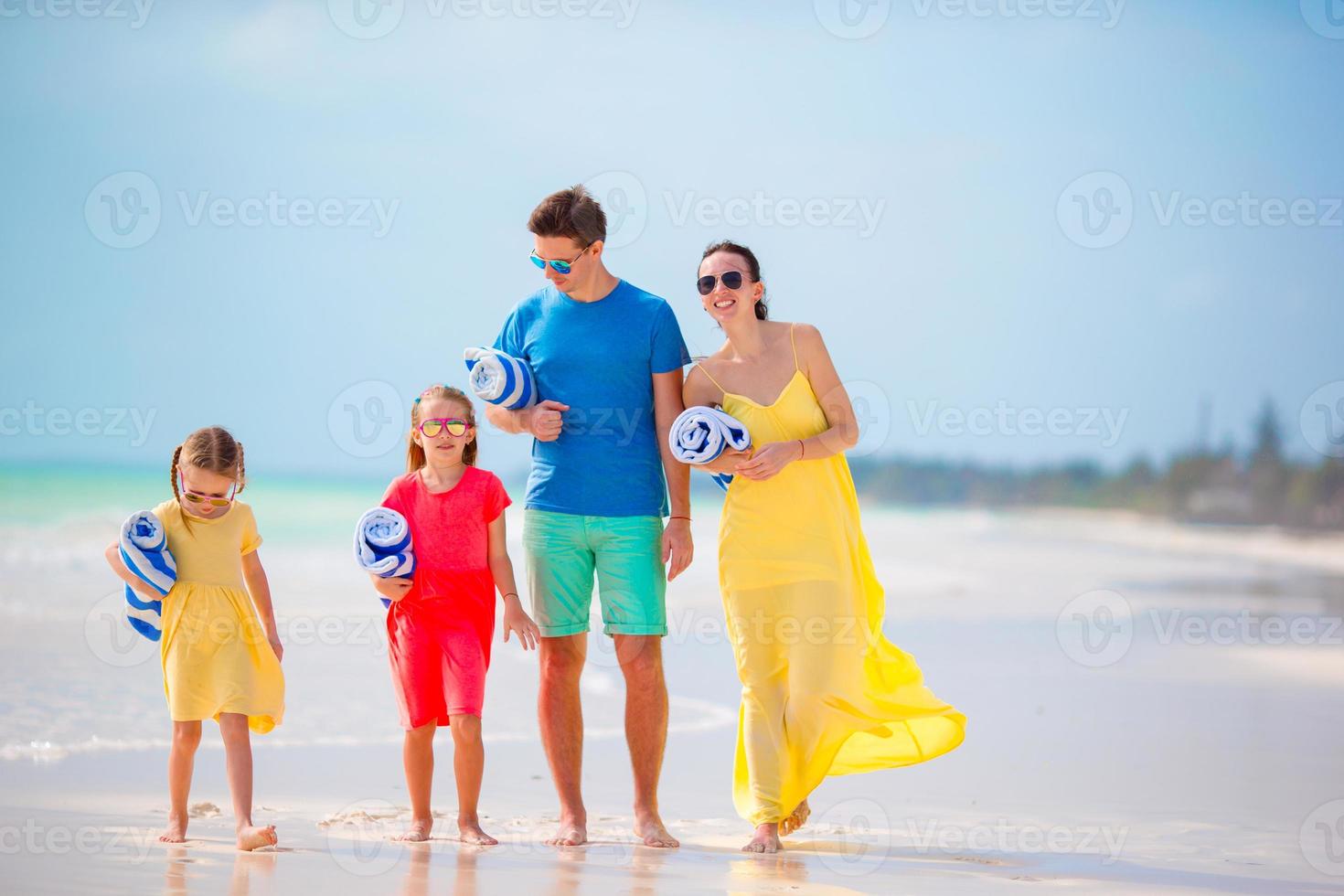 Young family with towels on vacation photo