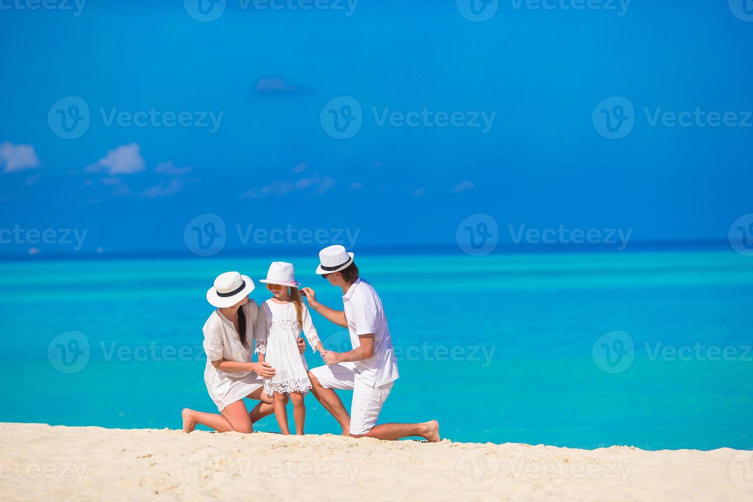 Happy family on white beach photo