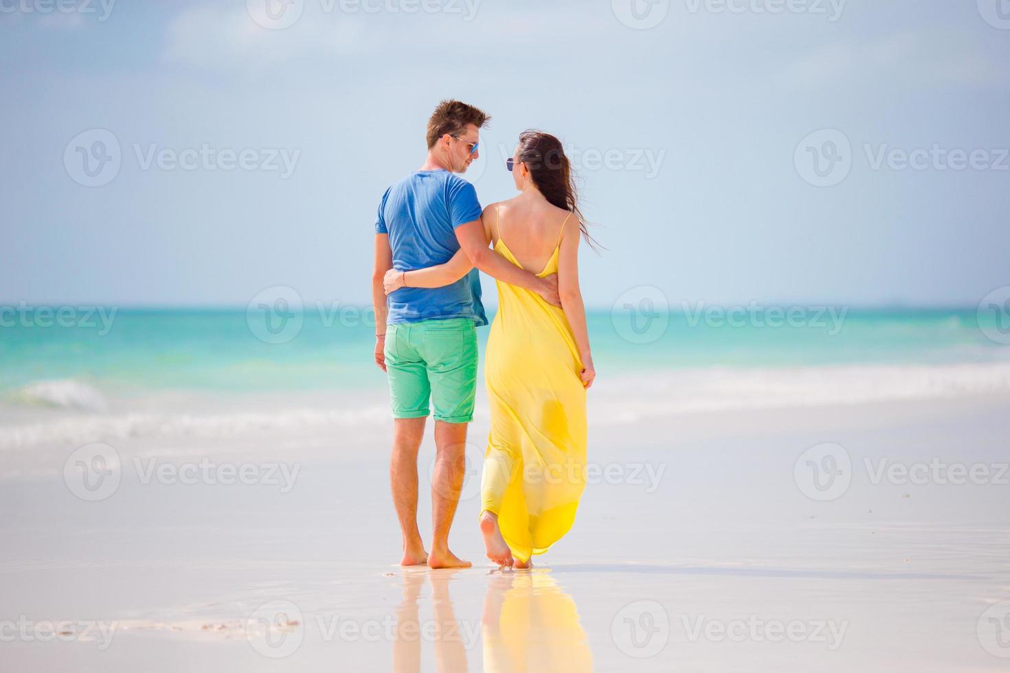 Young happy couple on white beach at summer vacation photo