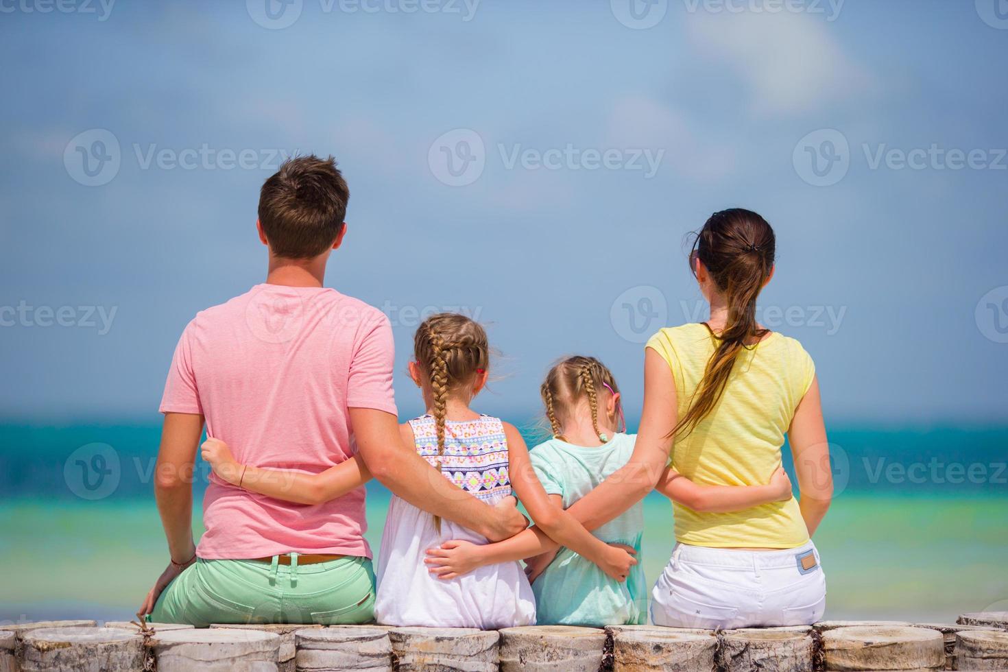 Young family of four on beach vacation photo