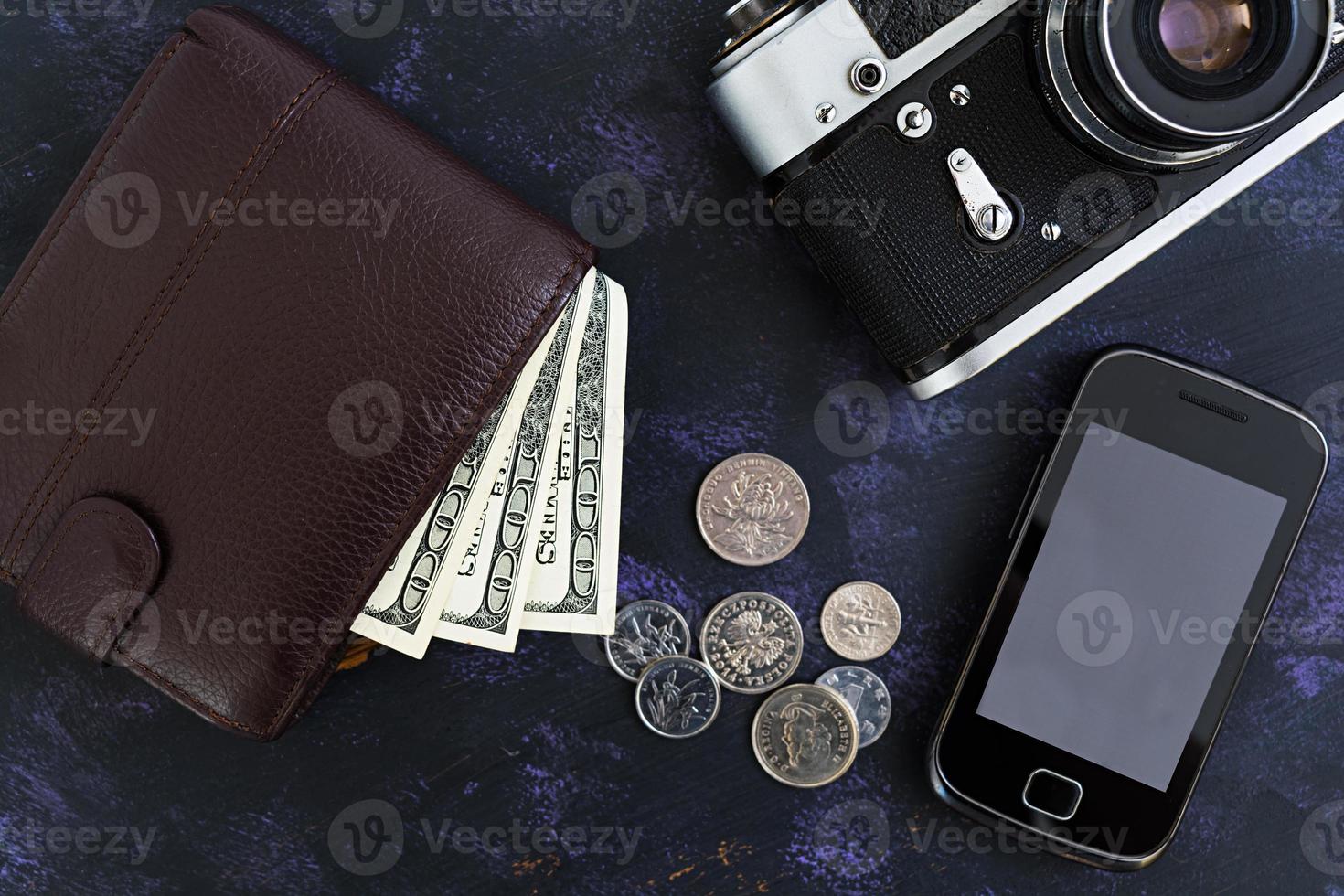 Retro camera, phone, money. Travel concept. Top view photo