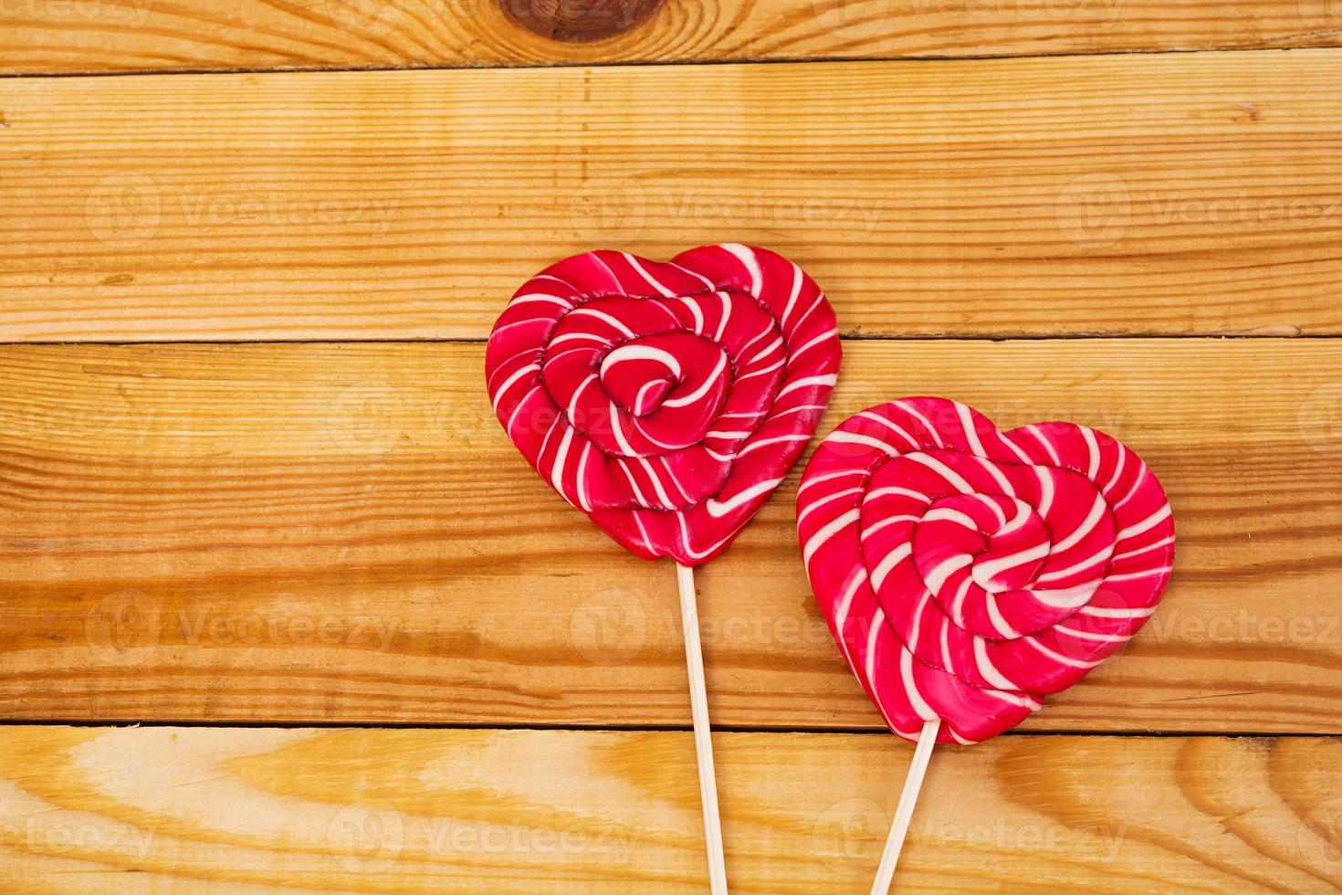 Colorful lollipops on wooden background. Top view photo