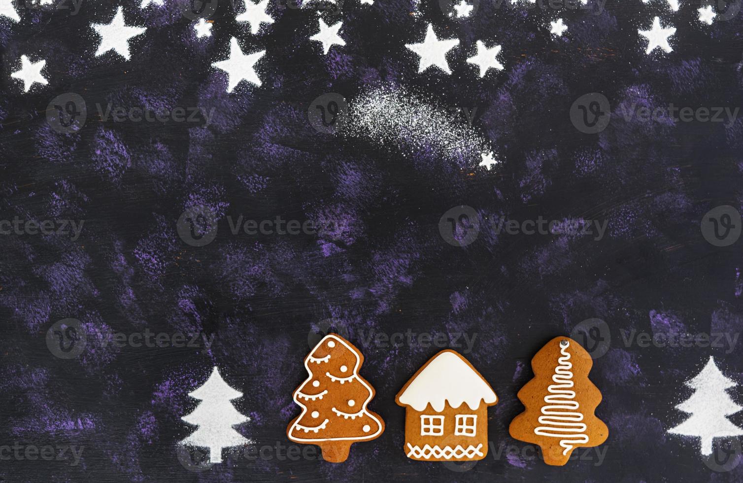 Christmas gingerbread cookies on dark background photo