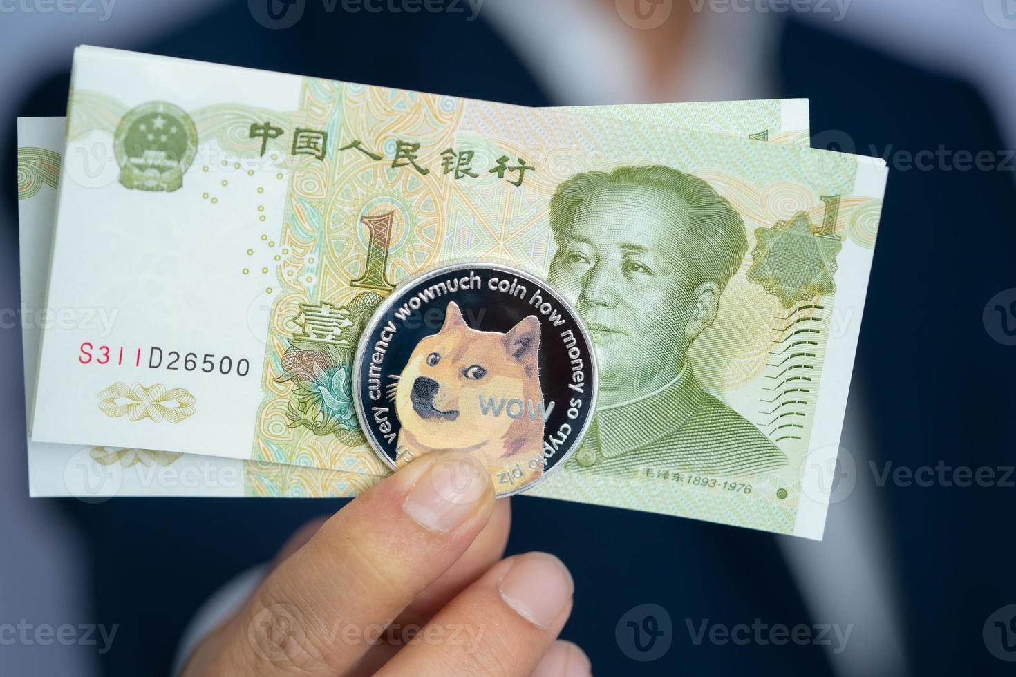 Focus select and blur Dogecoin doge and Chinese Yuan 1 one RMB, CNY with Crypto currency on hand business man wearing a blue suit. Filed and put and give to me. Close up and Macro photography concept photo