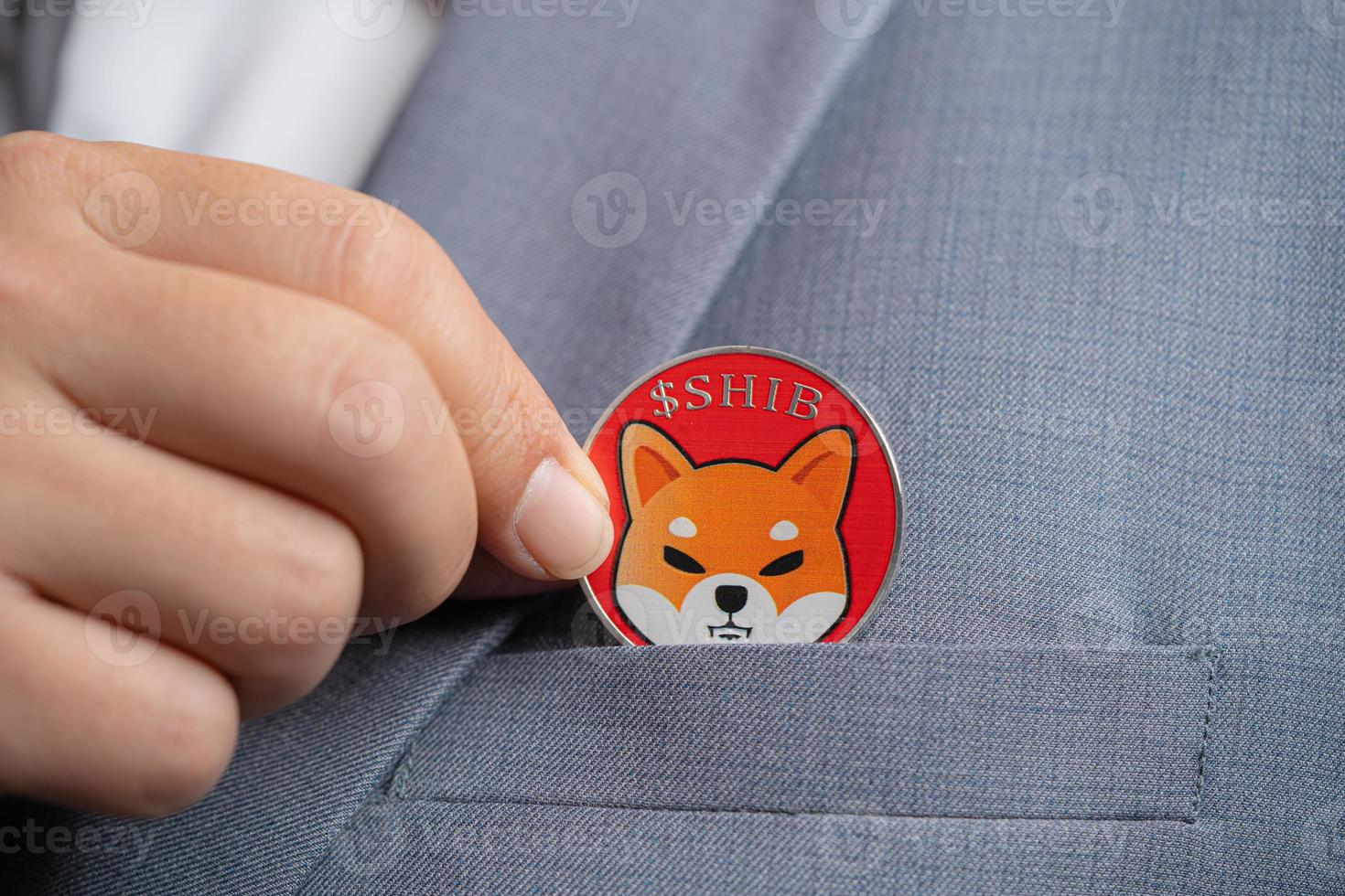 Focus select and blur Foreground Shiba coin SHIB included with Cryptocurrency hand picked in suit bag business man or bank employees wearing a gray suit. Filed and put and give to me. photo