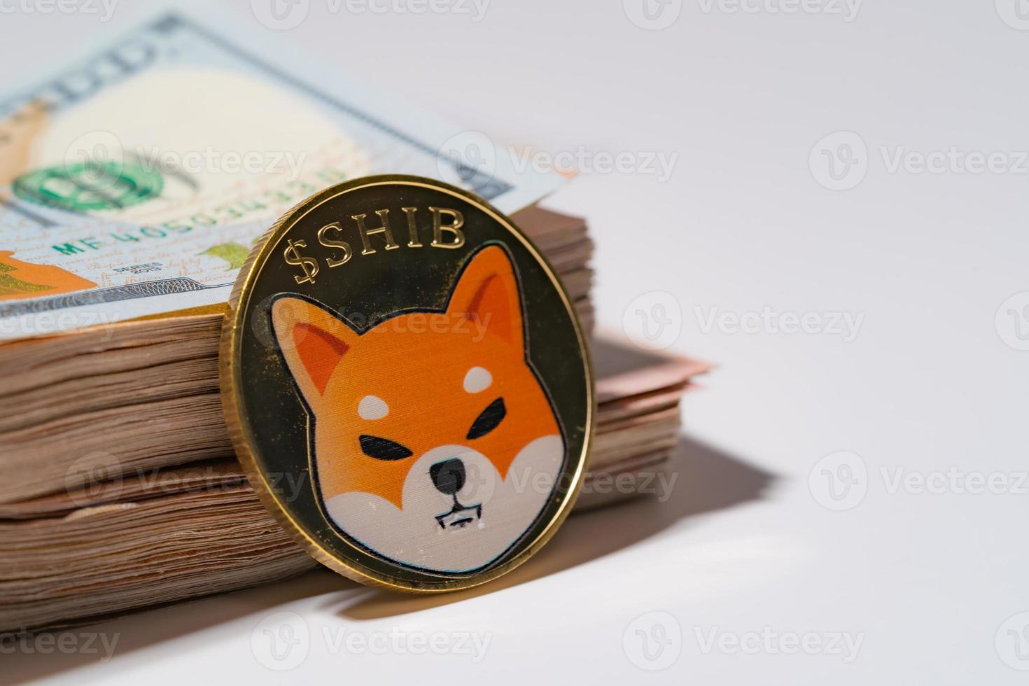 Shiba coin included with Cryptocurrency coin on stack 100 hundred new US dollar Money American Virtual blockchain technology future is money concept Close up and Macro on white background. photo